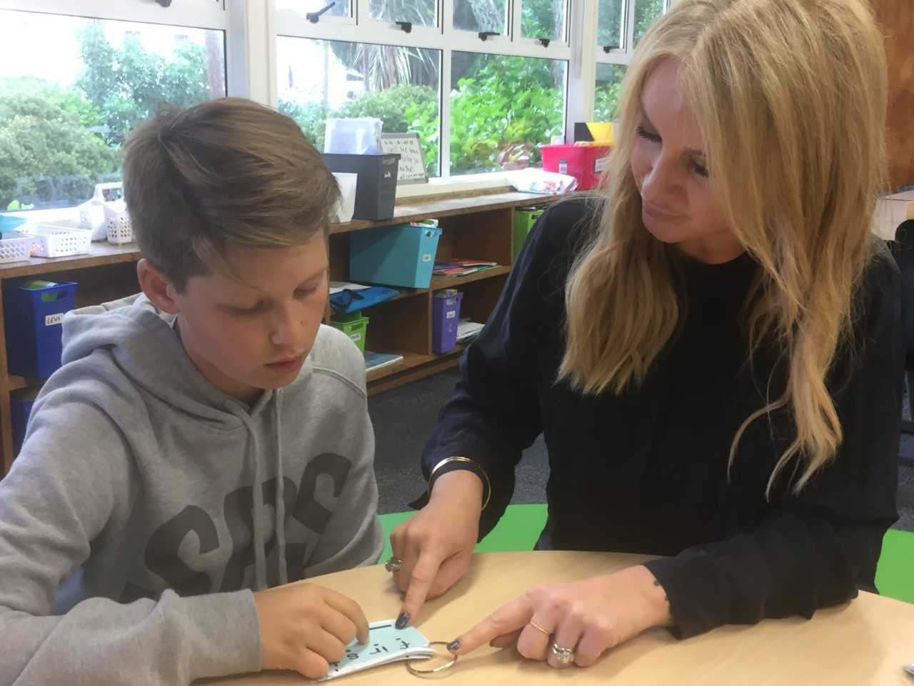 Boys like Jonathan Graham, 10 (left, pictured with Summit Point School founder Rebecca Elias), were falling behind in mainstream but are now leaping ahead. Photo / Simon Collins