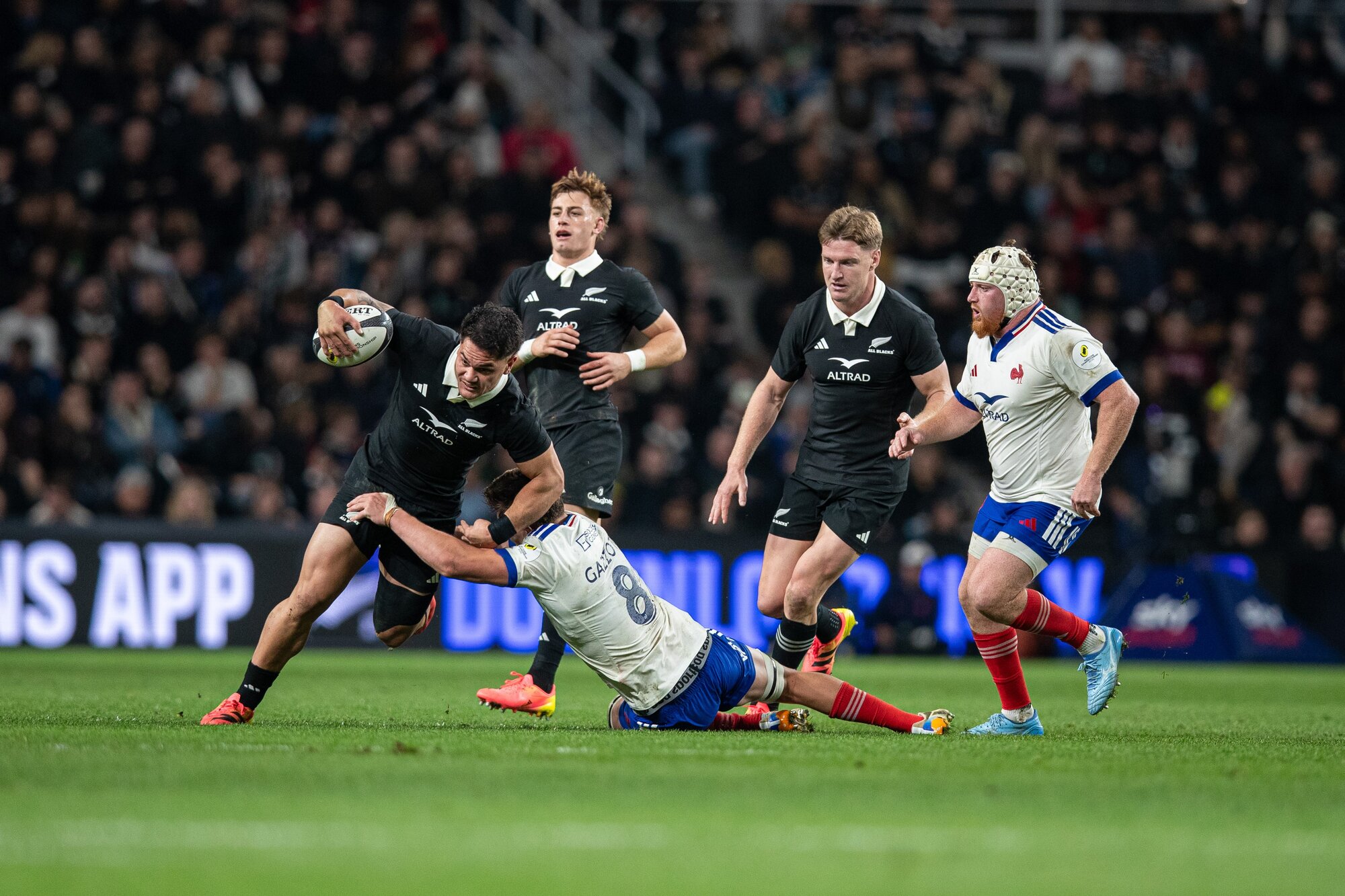 Quinn Tupaea tries to break out of a tackle in the All Blacks' test against France in Christchurch. Photo / Alyse Wright