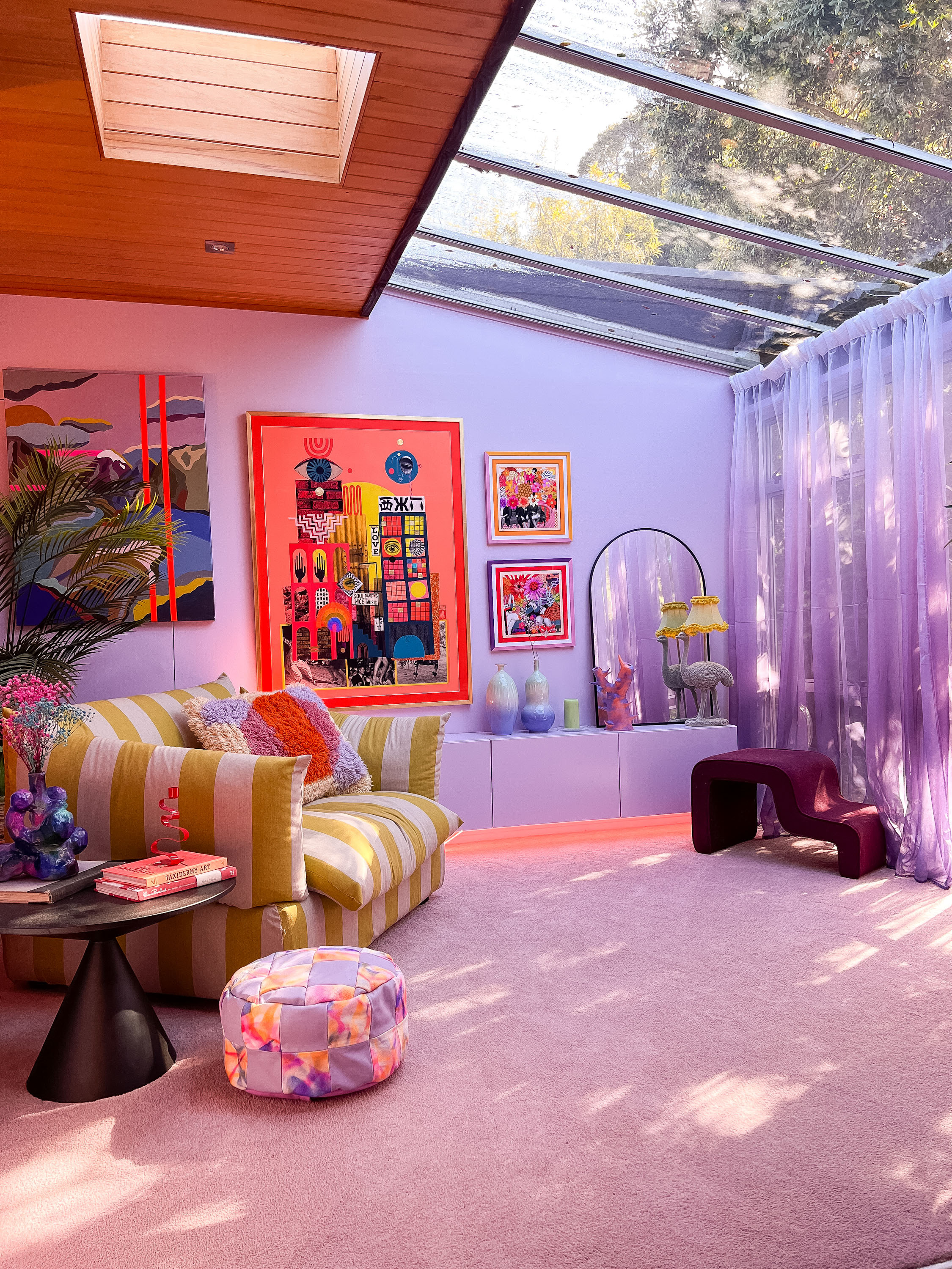 Evie’s living room boasts lavender walls and pops of neon.
