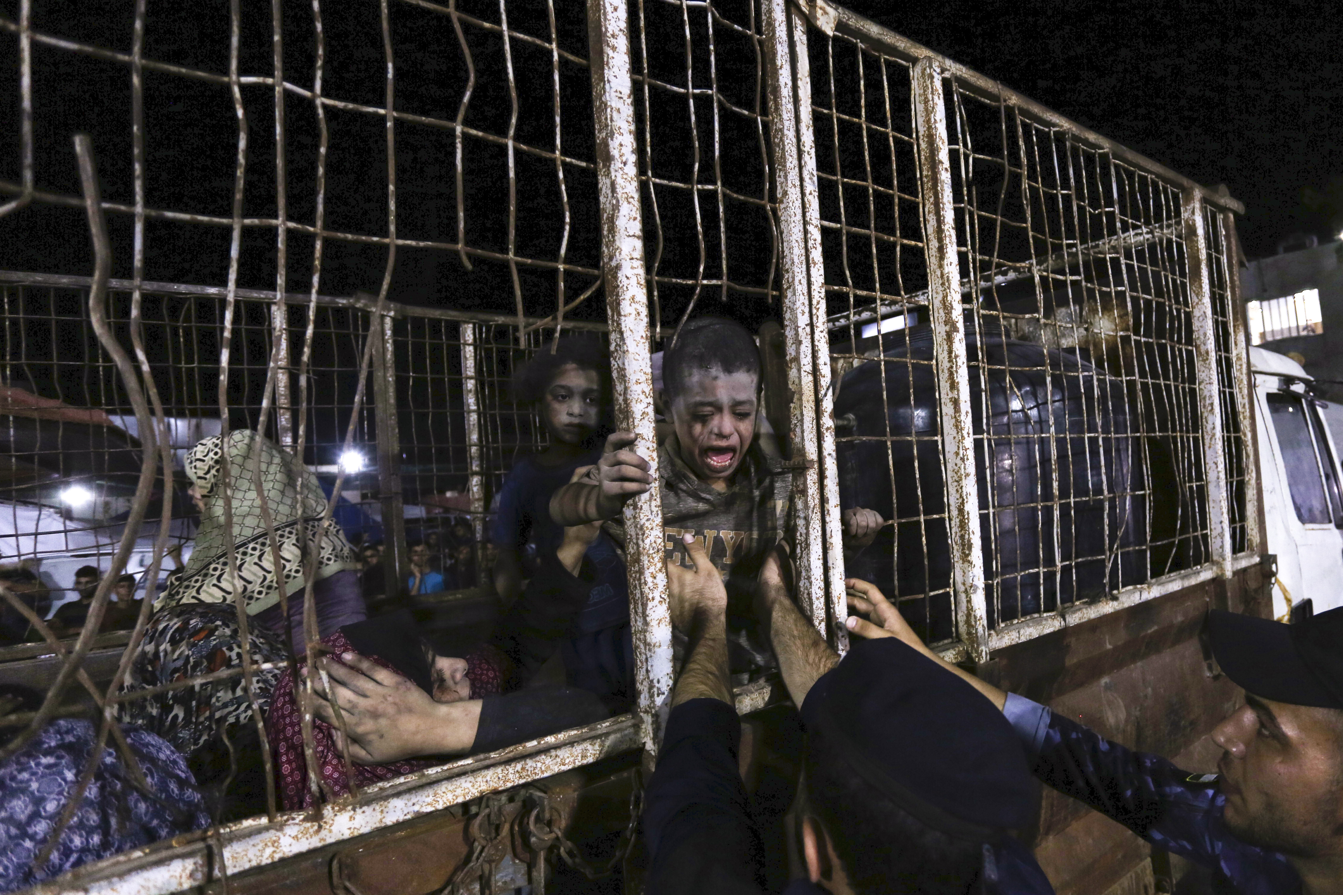 Wounded Palestinians arrive at the al-Shifa hospital on a truck after Israeli airstrikes on Gaza City. Photo / AP
