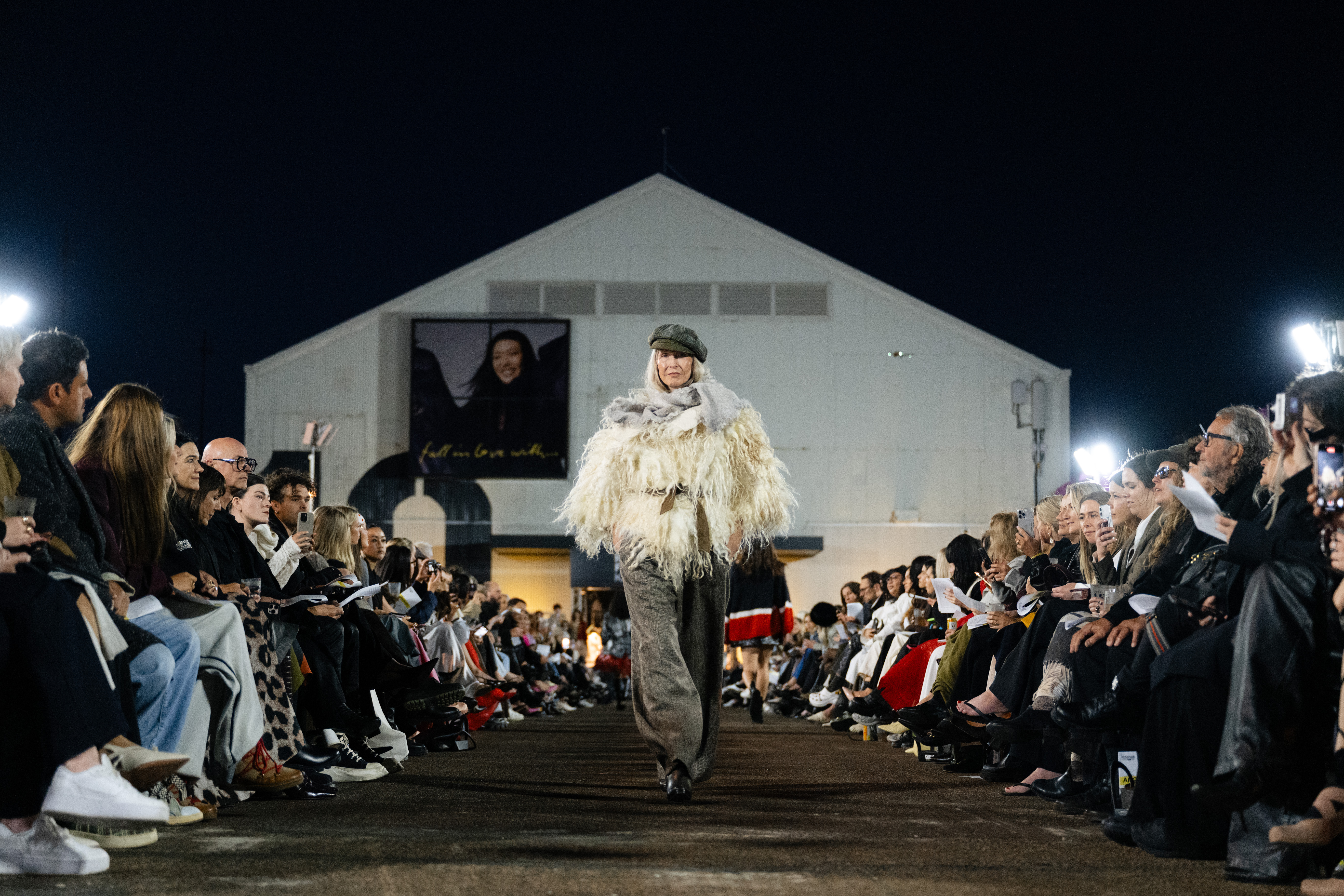 Amanda Bransgrove wears a Liz Mitchell jacket (2023), trousers (2025), scarf and belt and Hills Hat cap at NZFW 2025's Into The Archives show. Photo / Radlab