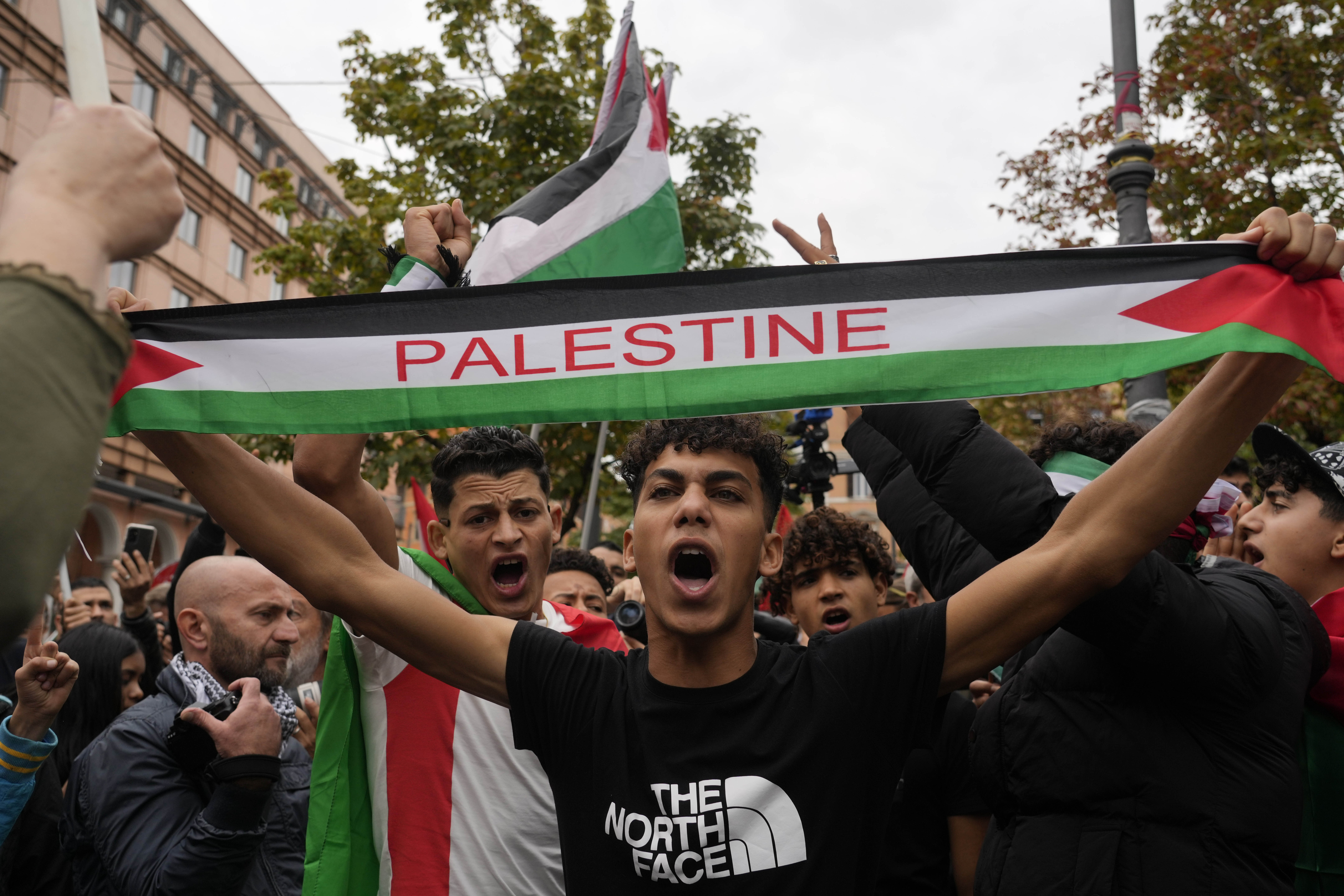 Protesters hold flags and shout slogans as they gather for a pro-Palestinian rally in Rome. Photo / AP