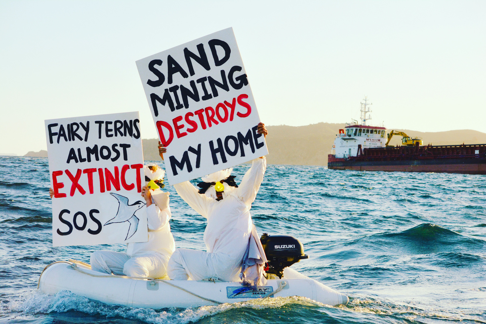 Pakiri seabed sand mining protesters voice their opposition as McCallums sand mining ship moves by. Pakiri and Mangawhai Sandspit are among the final stronghold of the endangered fairy tern
