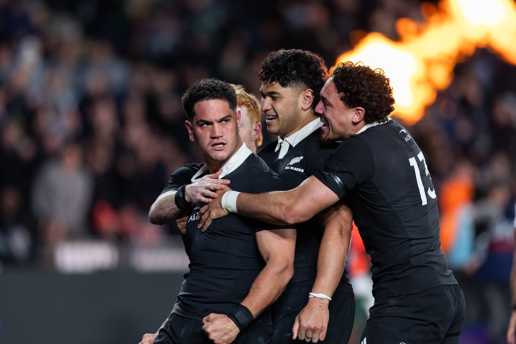 All Blacks midfielder Quinn Tupaea is congratulated after scoring. Photo / Photosport