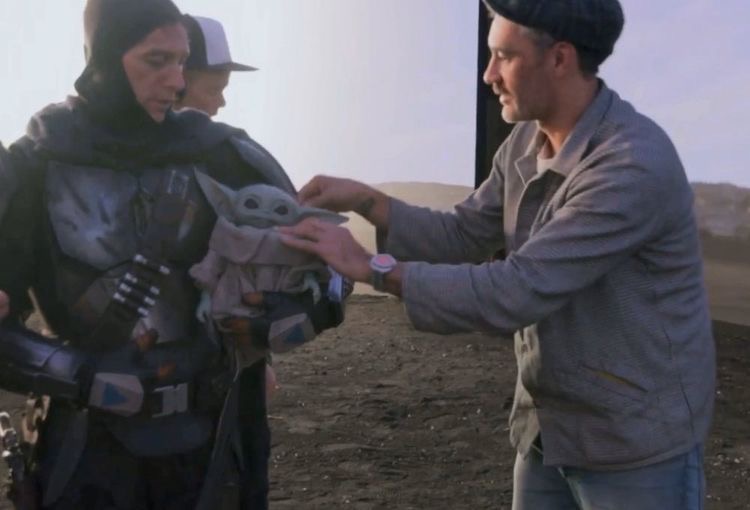 Brendan Wayne, left, on the set of The Mandalorian with 'Baby Yoda' and director Taika Waititi.