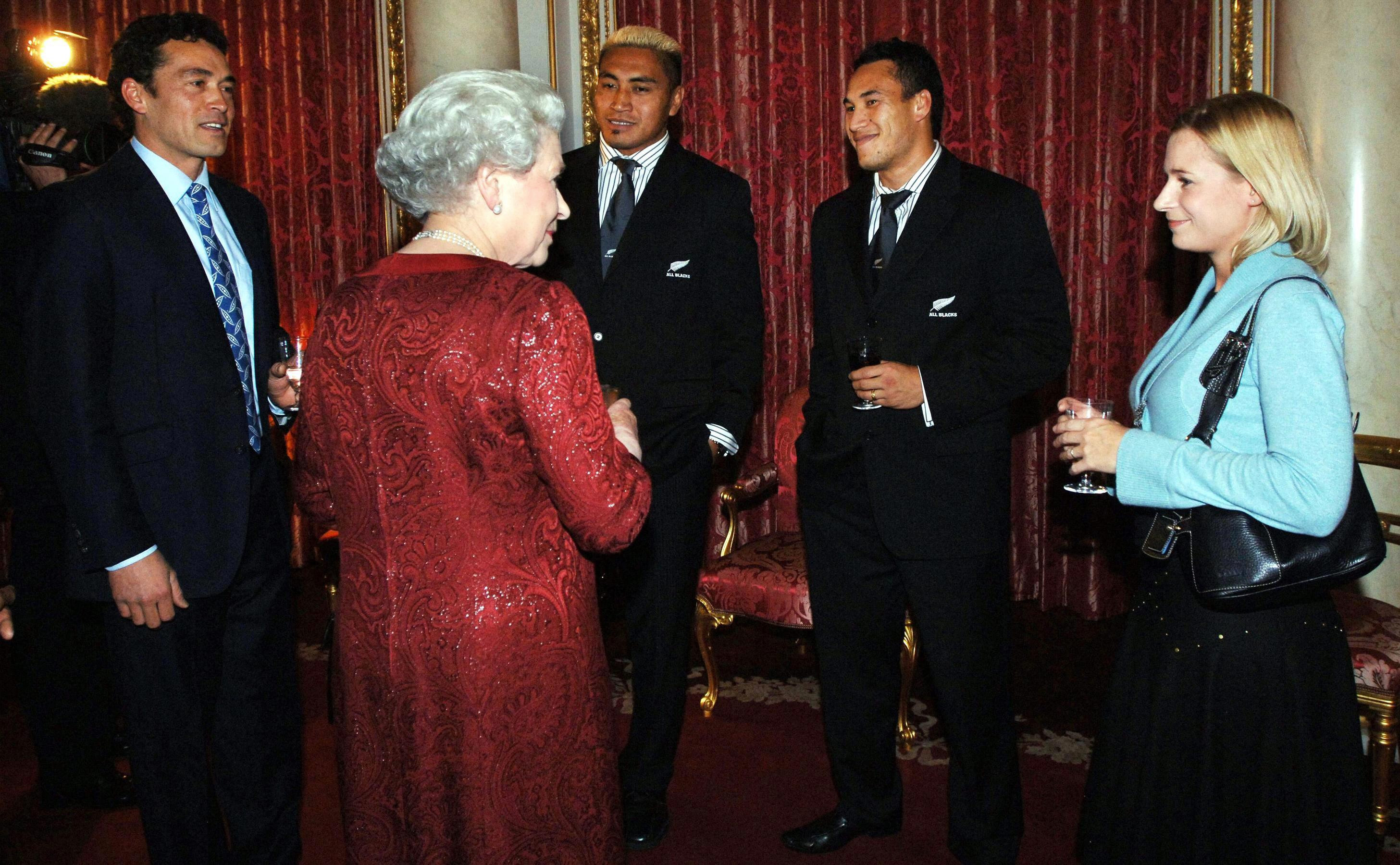 The Queen speaks to (from left) Gary Lewis, Jerry Collins, Rico Gear and Lady Davina Lewis. Photo / Getty Images