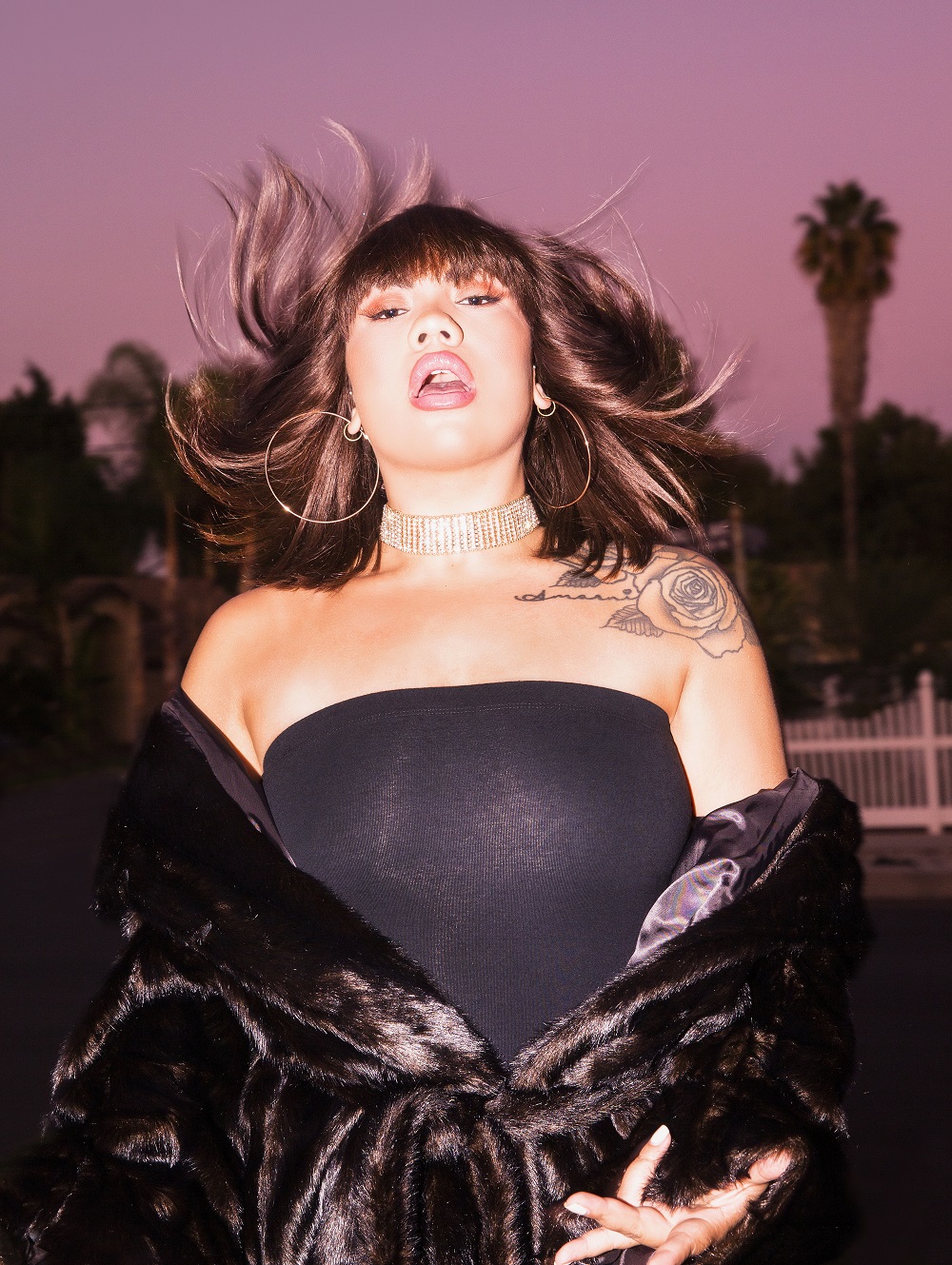 Parris wears H&M Studio faux fur coat, Carolina Bucci earrings and her own choker and top. Photo / Guy Coombes