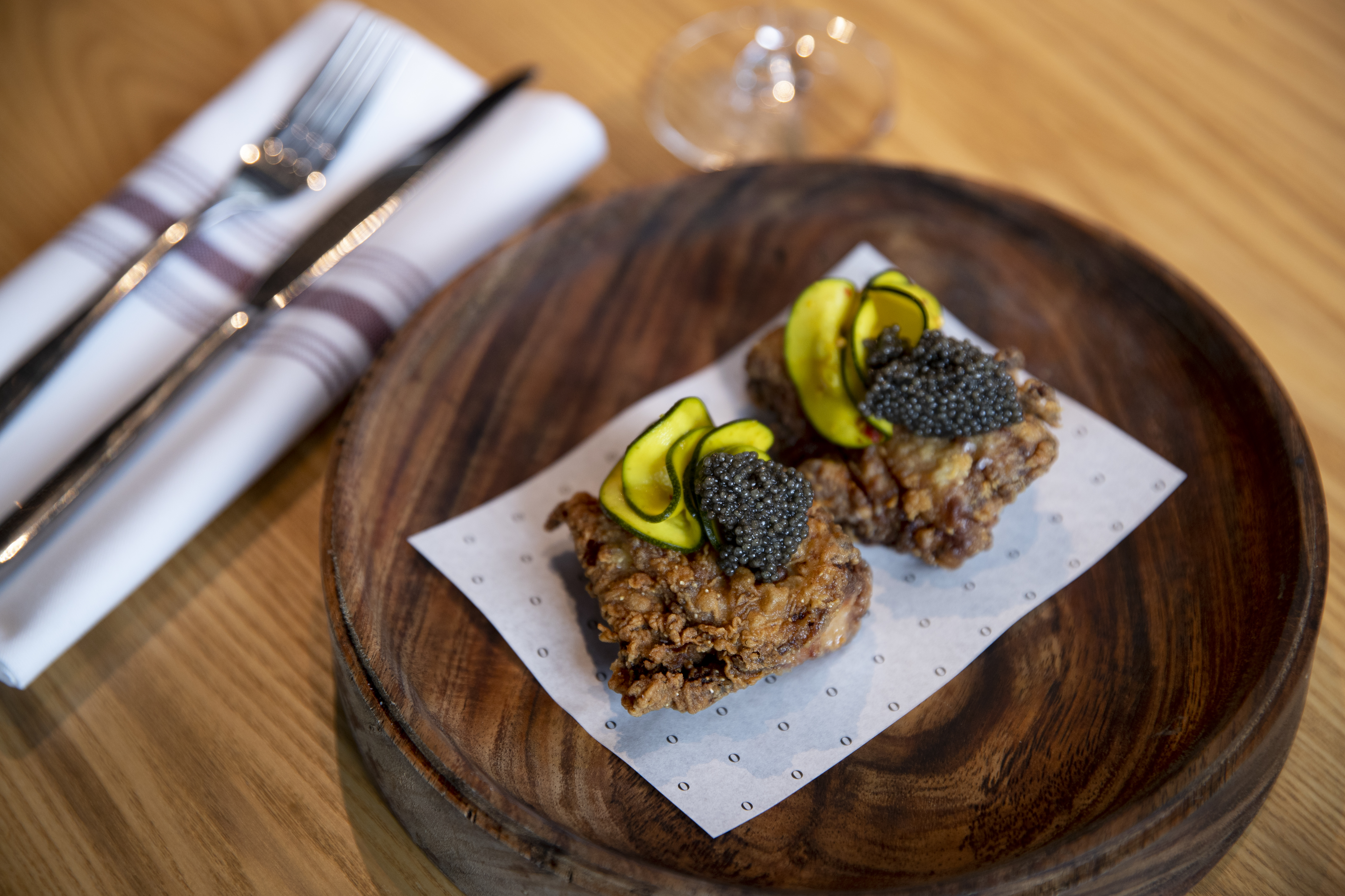 Small portions, expensive ingredients and big flavours. A favourite single-serve snack from Auckland restaurant Onslow features fried chicken, housemade pickles - and a dollop of caviar. Photo / Dean Purcell