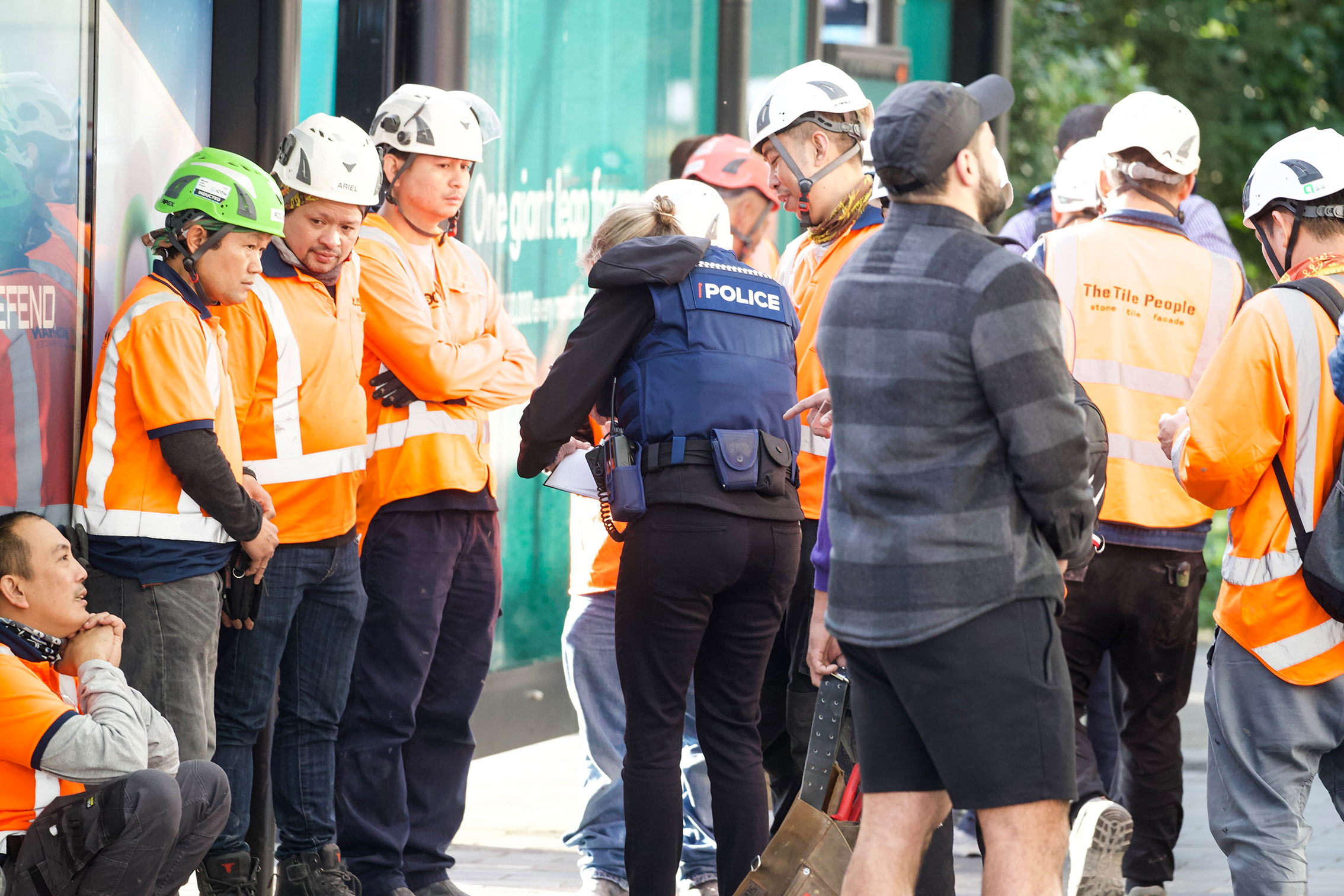 Police and construction workers in Downtown Auckland as police deal with the active shooter situation. Photo / Jason Oxenham