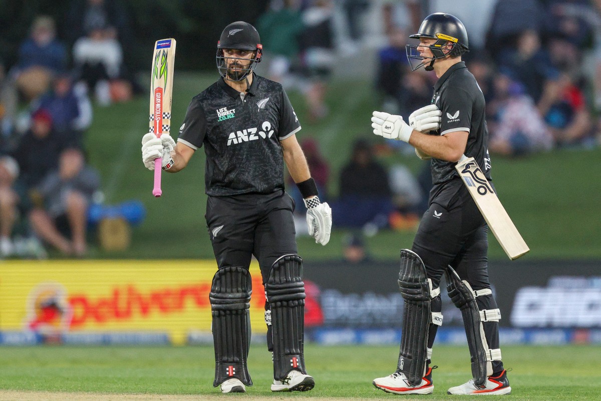 Daryl Mitchell celebrates his half-century in the first ODI between the Black Caps and England. Photo / AFP