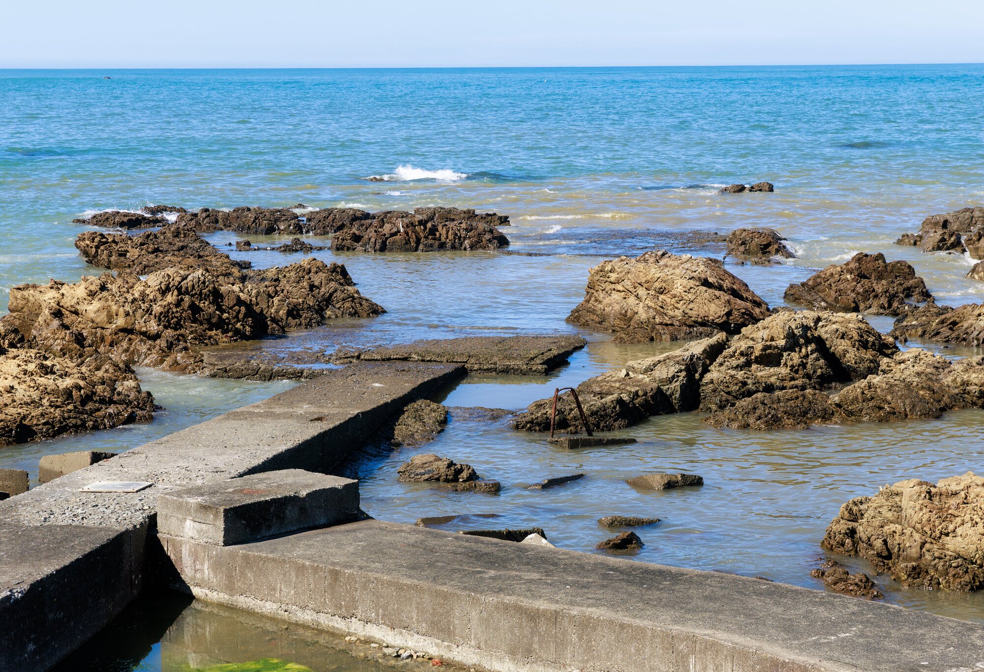 Raw sewage can be seen entering the water from the Moa Point Wastewater Treatment Plant's outfall pipe, metres from the shore at Tarakena Bay. Photo / Mark Mitchell