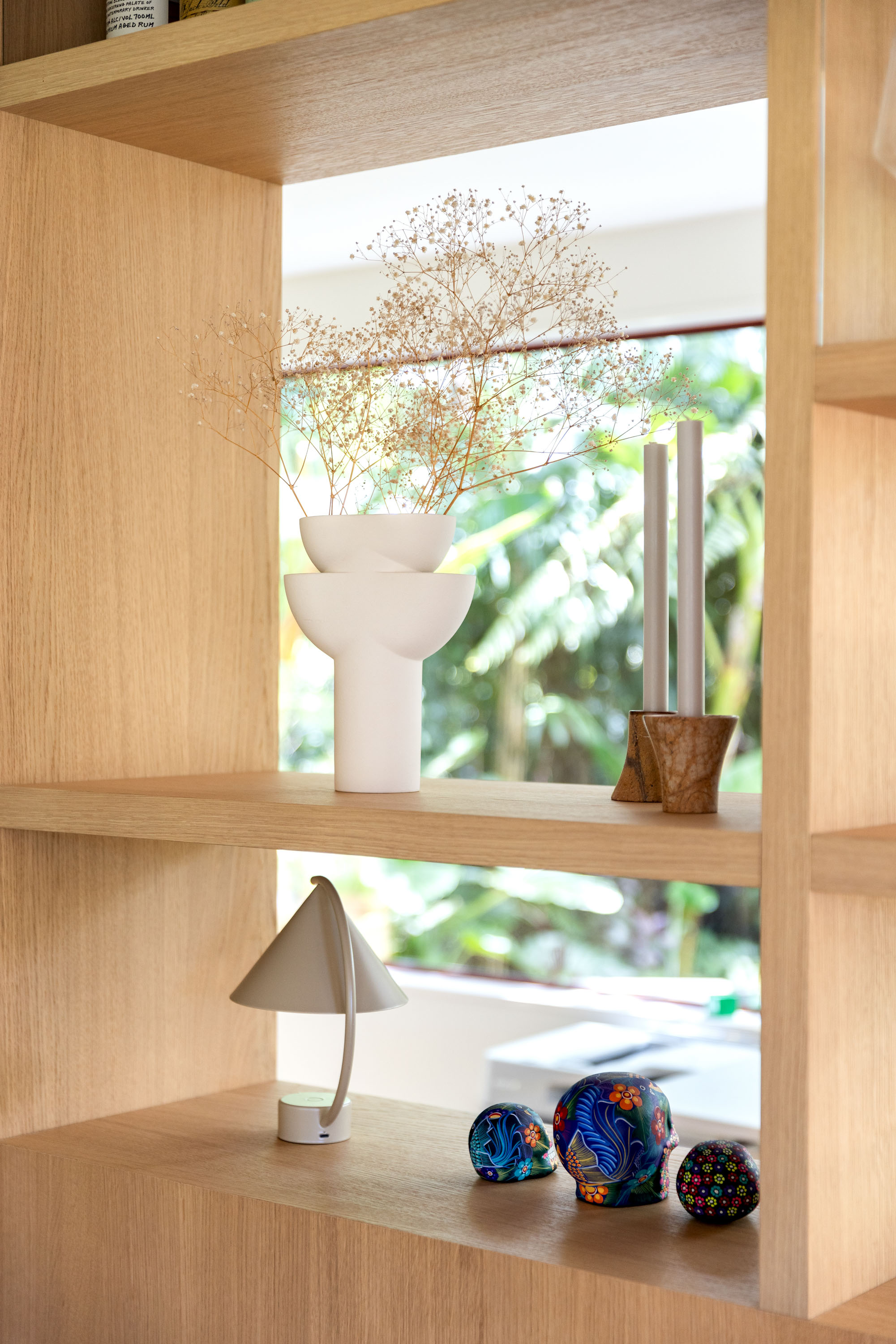 A curated selection of mementos on the bookshelf. Photo / Babiche Martens