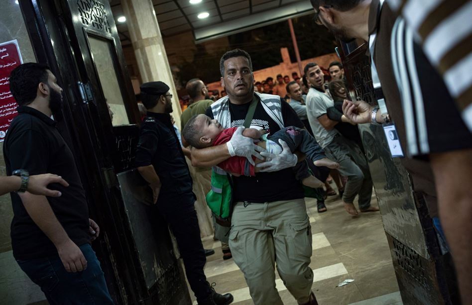 A wounded Palestinian child is carried into the Nasser Medical Complex, following Israeli airstrikes on the town of Khan Younis, southern Gaza Strip. Photo / AP