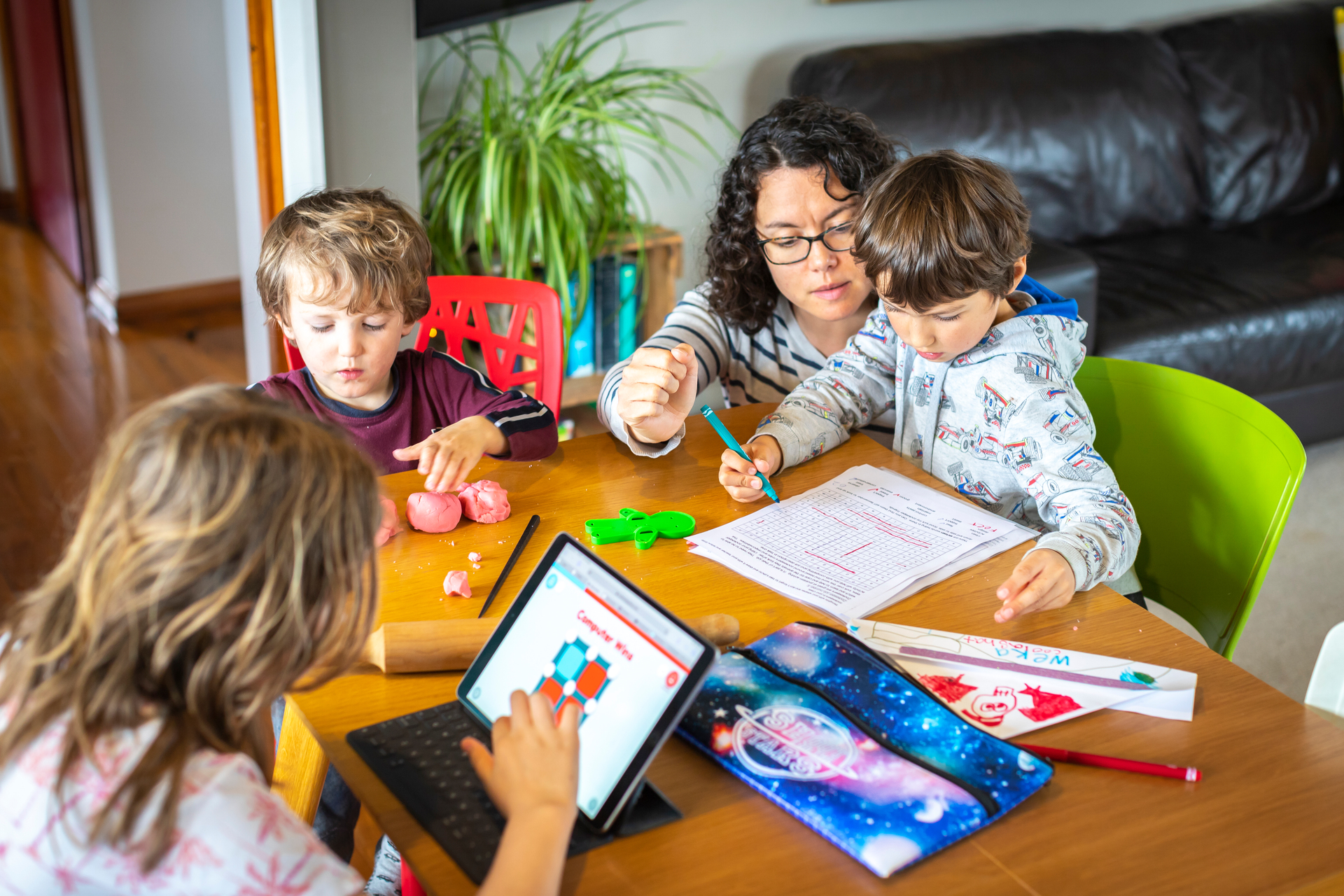 Lisa Carter has to juggle online and offline learning to keep her kids, from left Olivia, 9, Reuben, 3, and Levi, 6, engaged during lockdown. Supplied photo / Alex Carter