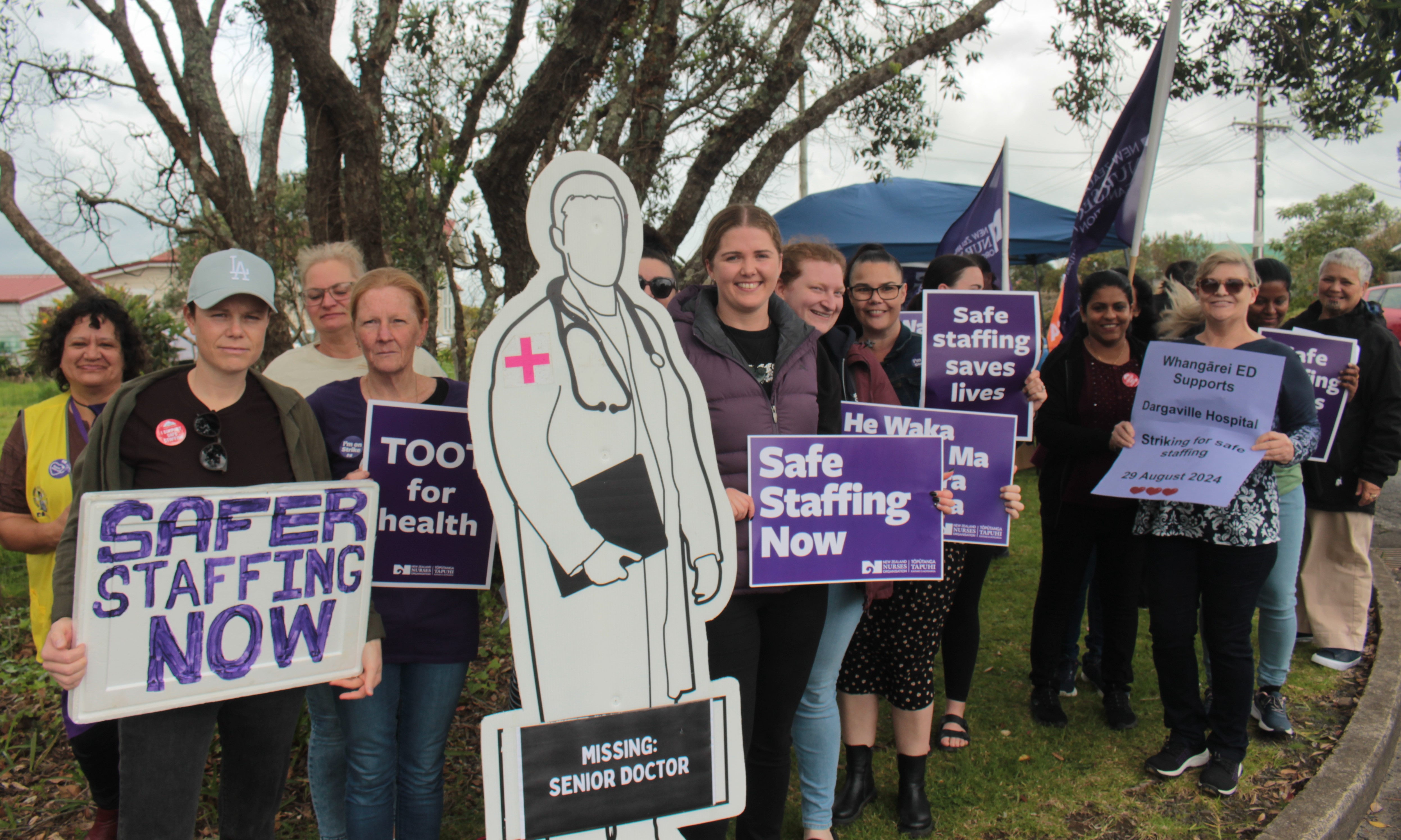 Dargaville Hospital nurse Rachyl Randell, centre, standing with colleagues and supporters, says the lack of doctors during overnight shifts is a concern. Photo / Denise Piper
