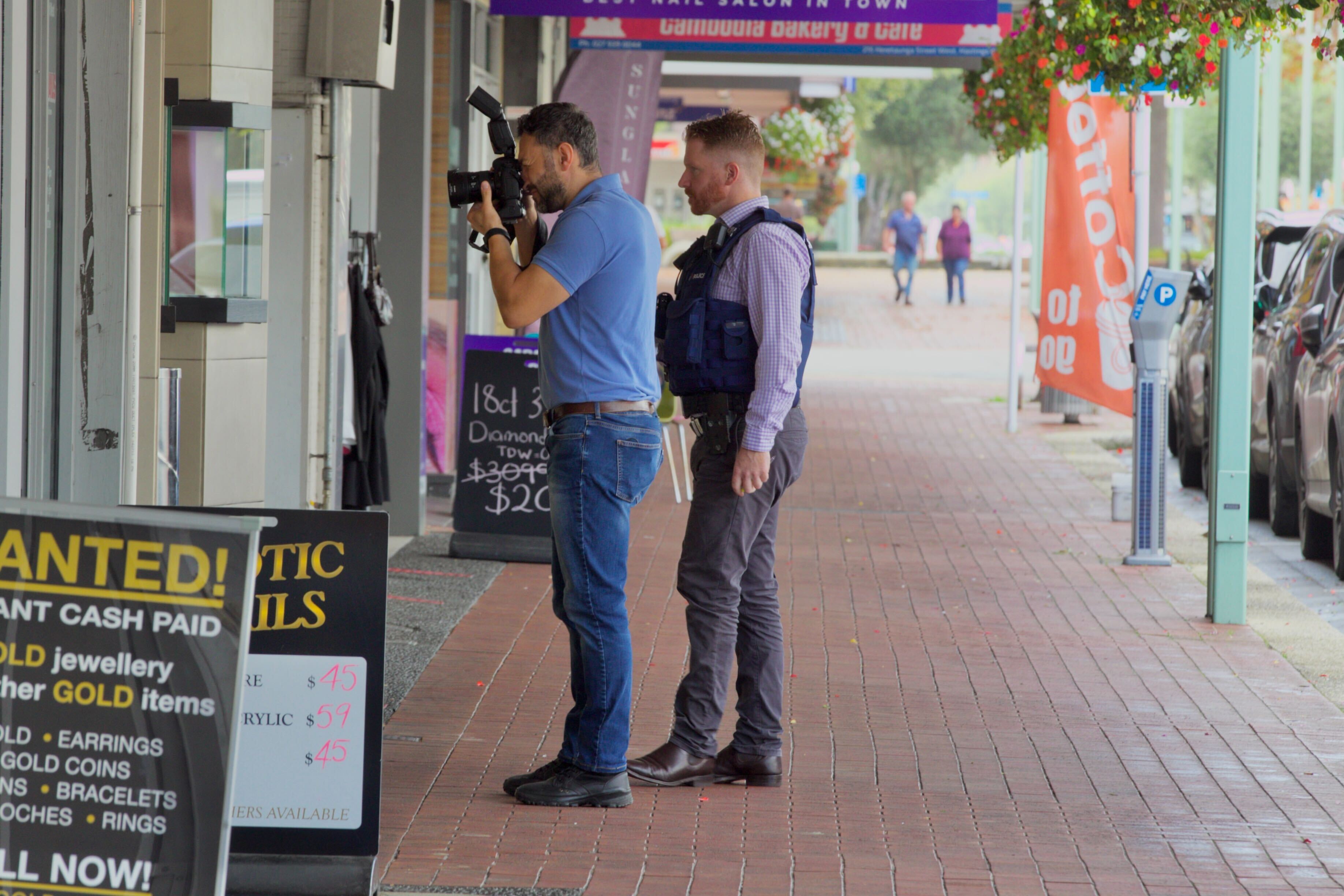 Police photograph the scene after a burglary at the Michael Hill Jeweller in Hastings. Photo / Warren Buckland