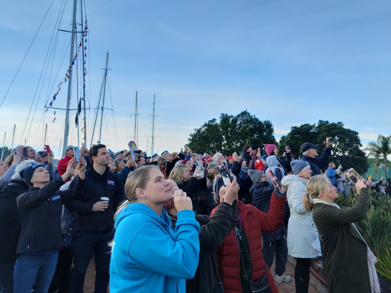 Hundreds gathered to watch the spectacle, faces upturned as they recorded the event. Photo / Jodi Bryant