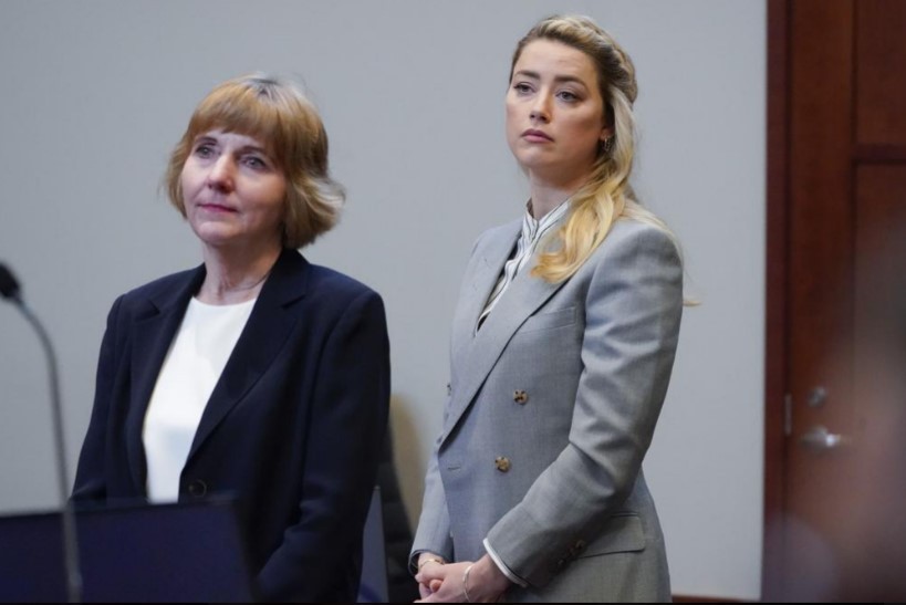 Actor Amber Heard stands with her attorney Elaine Bredehoft in the courtroom. Photo / AP