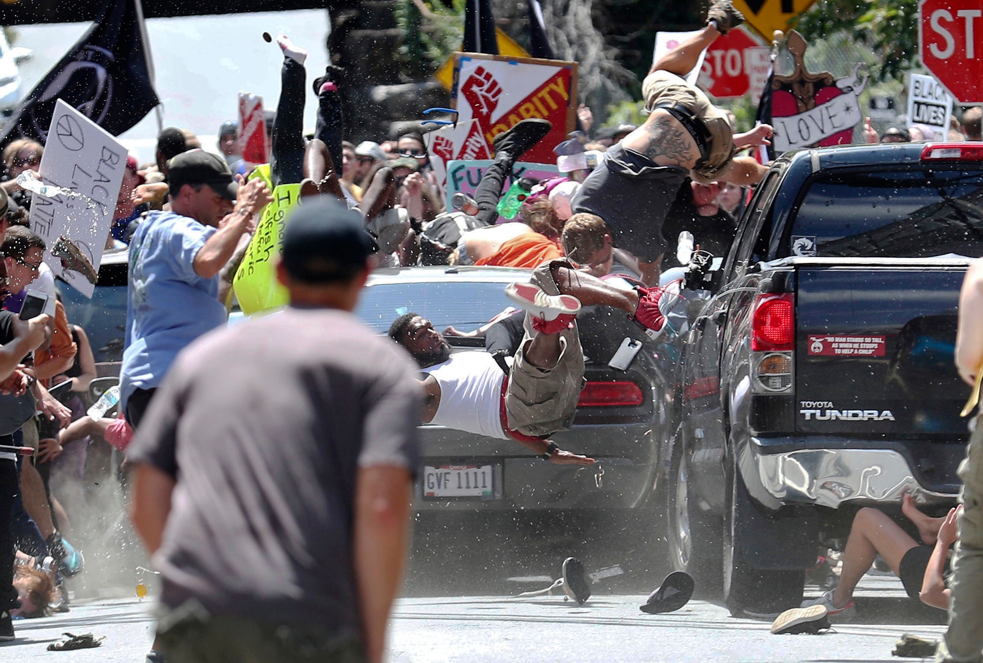 People fly into the air as a vehicle hits protesters demonstrating against a white nationalist rally in Charlottesville. Photo / Ryan M. Kelly of the Daily Progress via AP