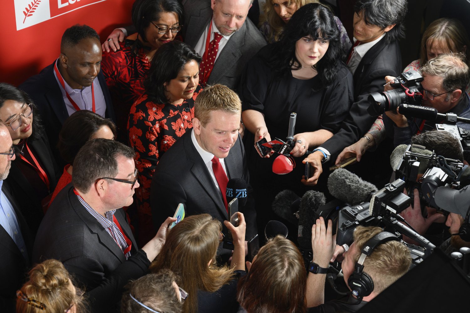 New Zealand Prime Minister Chris Hipkins, centre, speaks to media after conceding at a party event in Wellington. Photo / AP