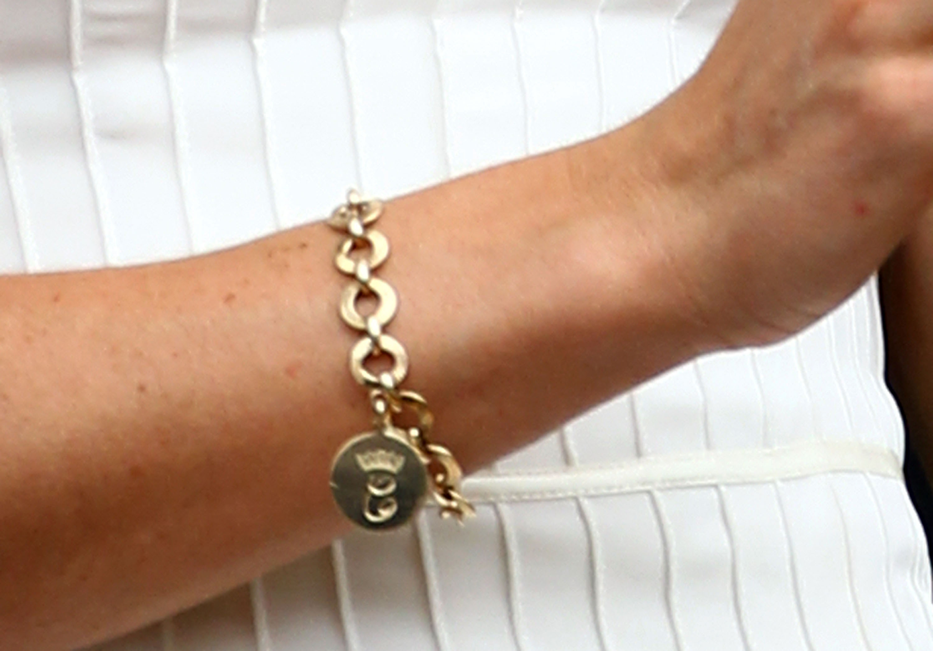 Shortly after her wedding in 2011 Kate was pictured on several occasions wearing an elegant gold charm bracelet with two 'Cs' engraved on it. Photo / Getty