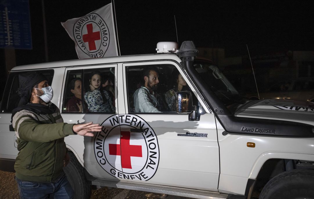A Red Cross vehicle carrying Israeli hostages drives by at the Gaza Strip crossing into Egypt in Rafah. Photo / AP