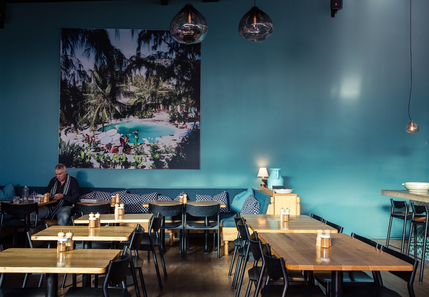 Odettes dining room, featuring a retro Slim Aarons print. Photo / Babiche Martens