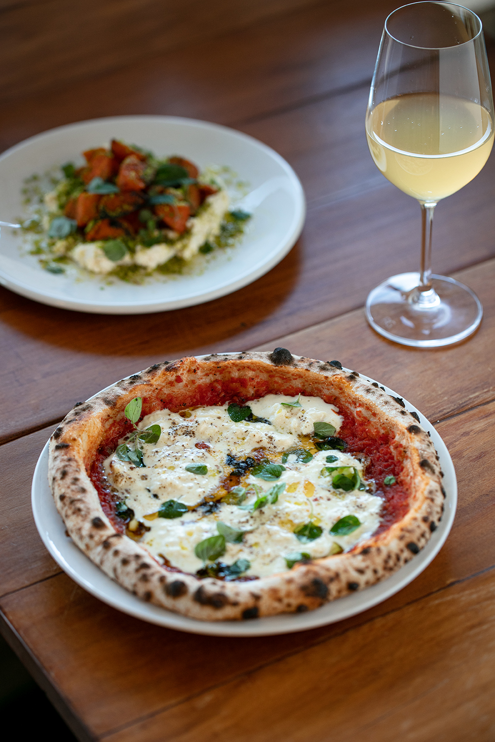 The tomato and stracciatella pizza and the carrots with ricotta at Ooh-Fa. Photo / Babiche Martens