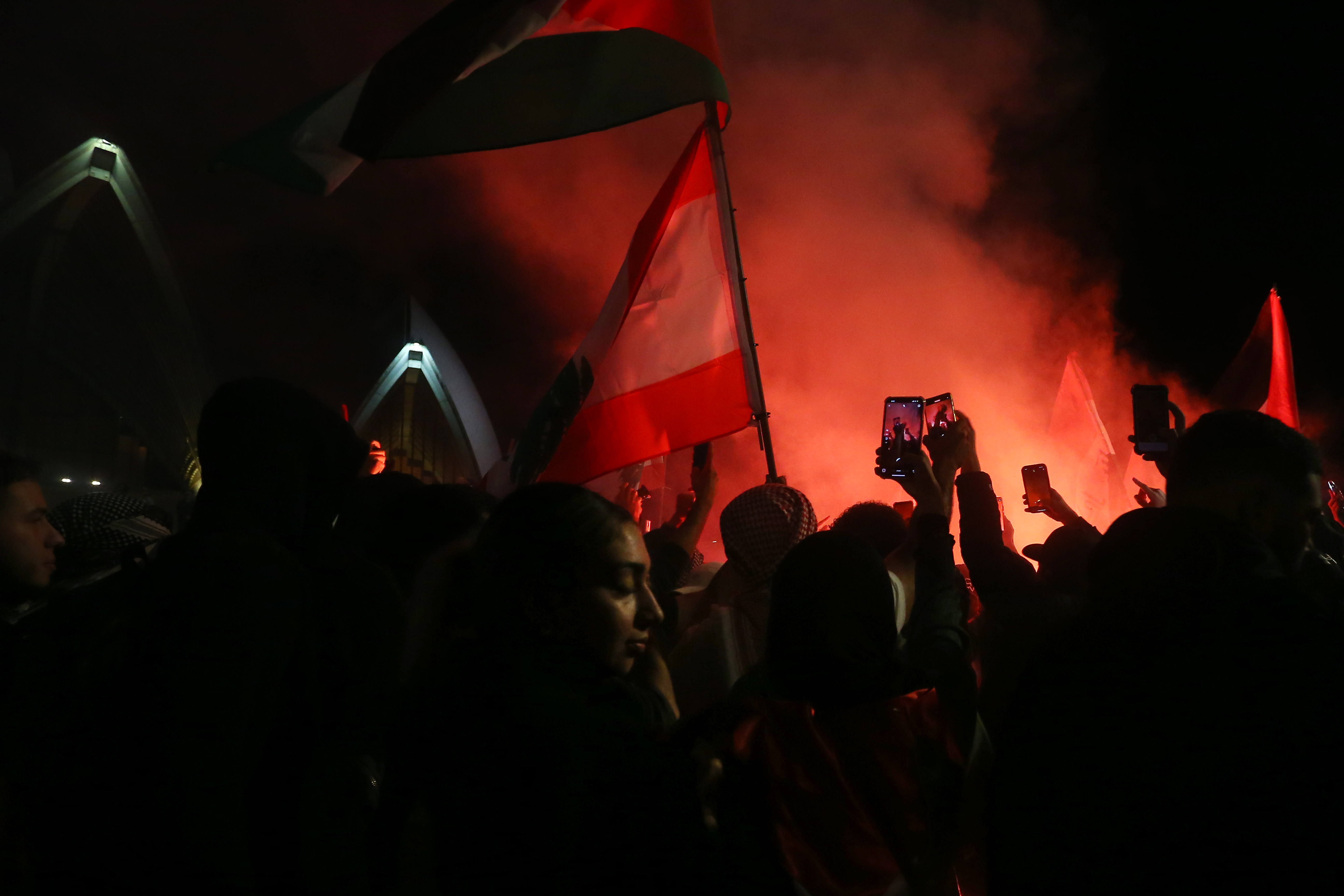 Palestine supporters ignite flares during the rally in Sydney on Monday. Photo / Getty Images