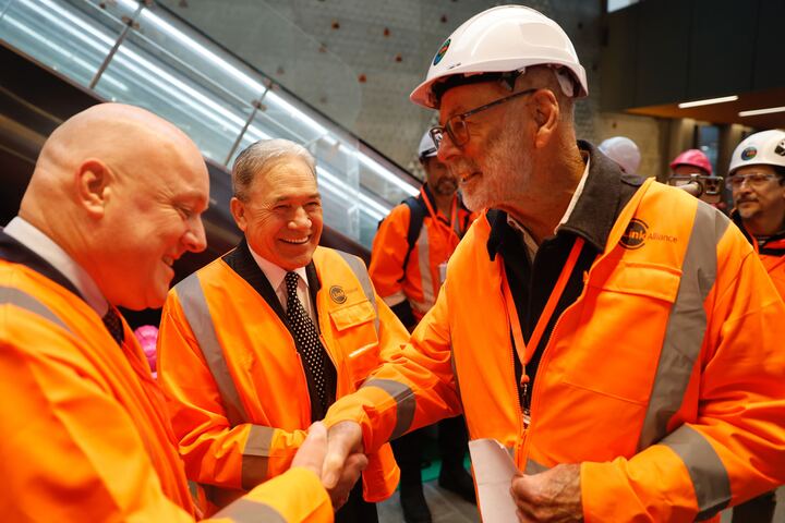 Prime Minister Christopher Luxon (left), NZ First leader Winston Peters (centre) and Auckland Mayor Wayne Brown exchange greeting before an historic passenger ride this morning on the City Rail Link. Photo / Michael Craig