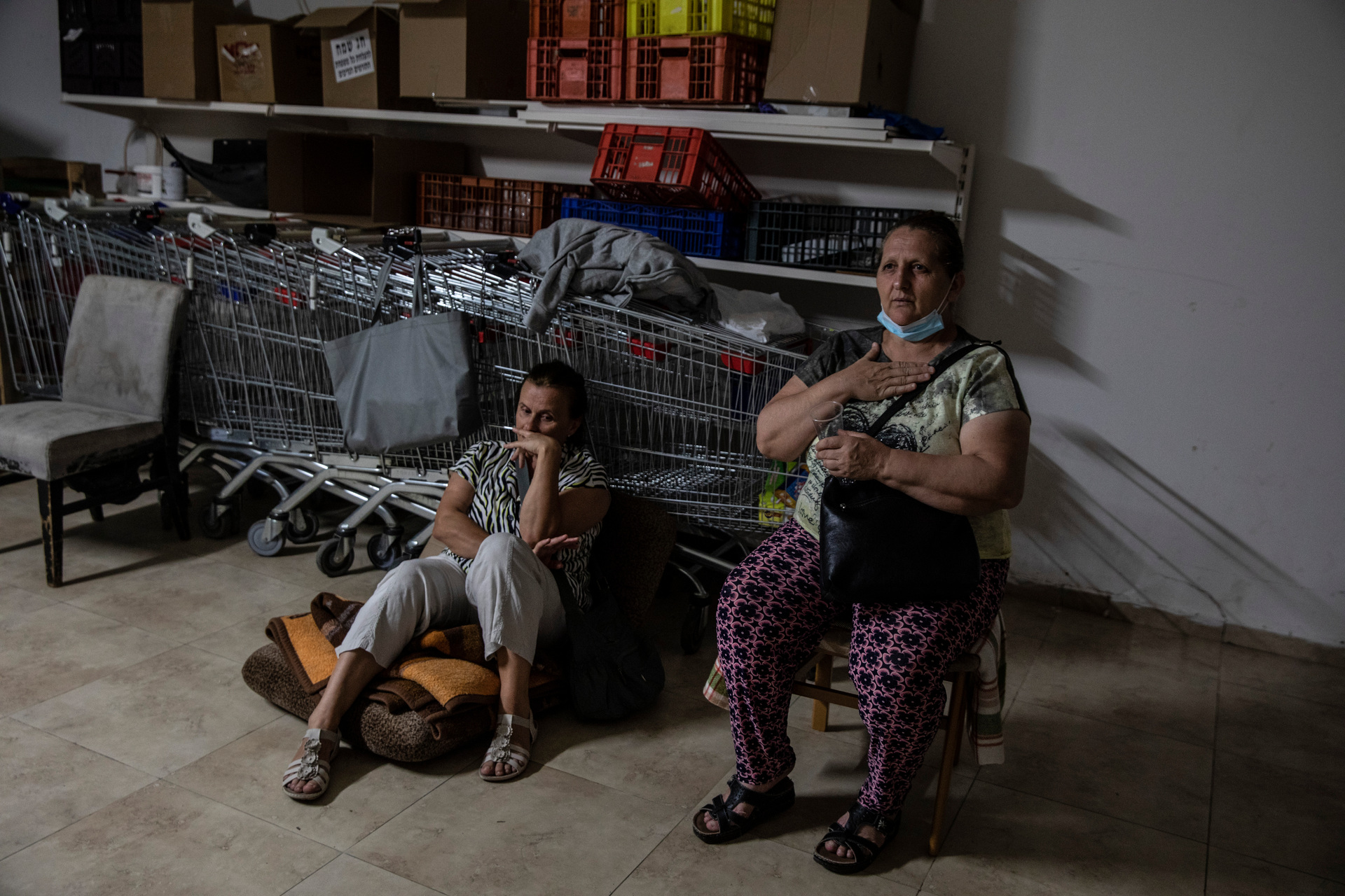 Israeli Kassadra Bodari, left, and Lilian Feciouru take shelter in Ashdod, Israel during sirens warning of incoming rockets fired from Gaza Strip. Photo / AP
