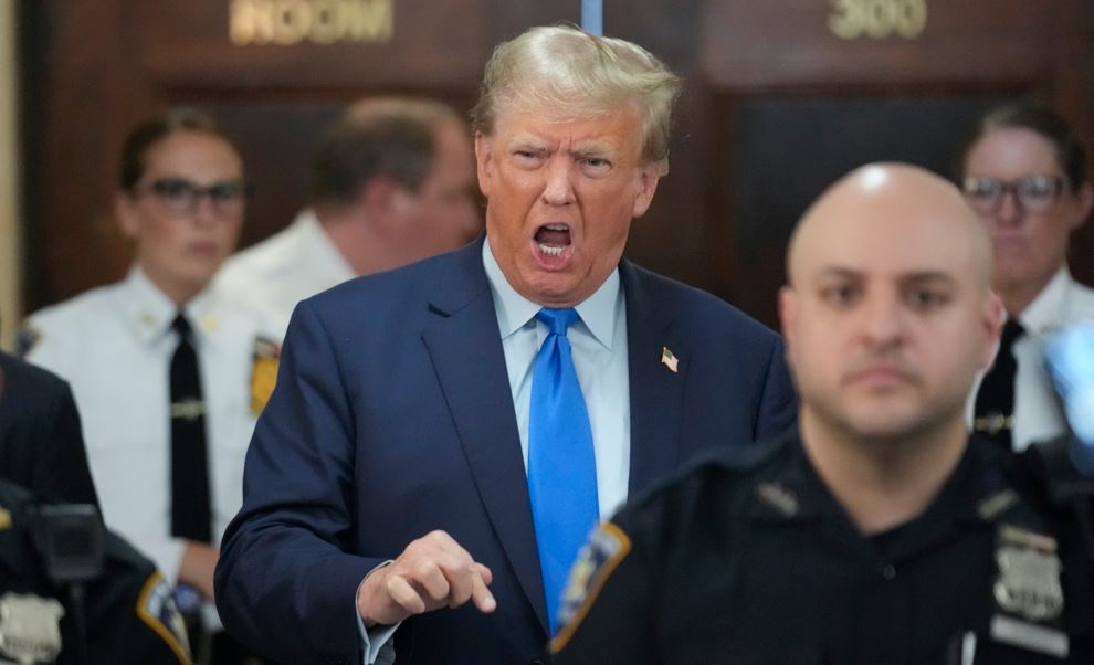 Former President Donald Trump speaks to reporters during a lunch break. Photo / AP