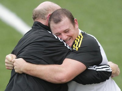 Tony Woodcock wrestles with scrum coach Mike Cron during an All Blacks training session. Photo / Mark Mitchell