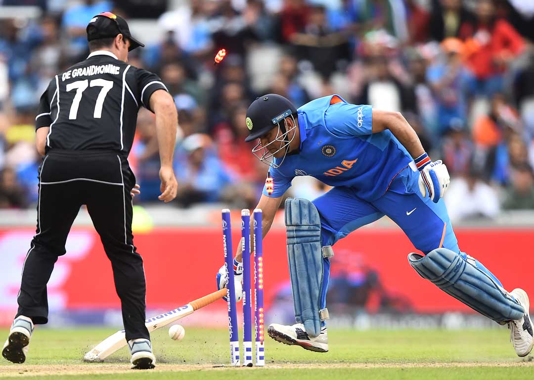 MS Dhoni is run out by Martin Guptill. Photo /Getty