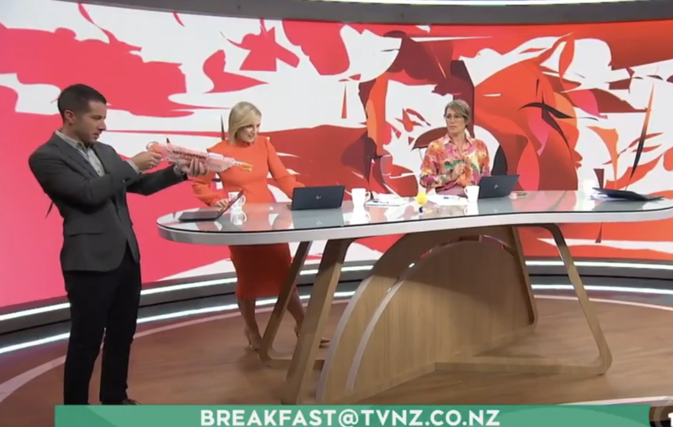 The Breakfast team watched on as Chris Chang shot at the Donald Trump doll. Photo / TVNZ