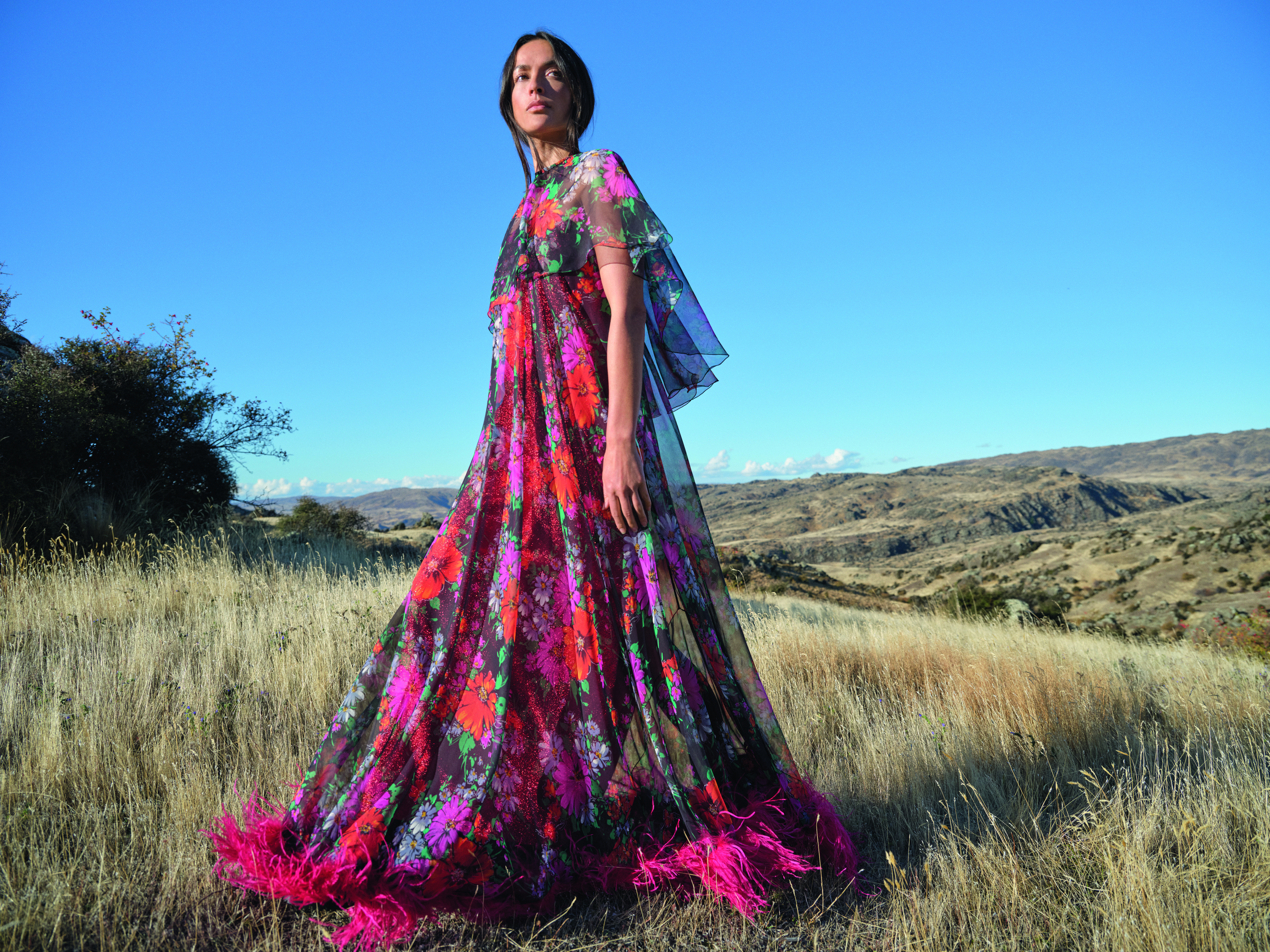 An early 1970s Vinka Lucas evening dress and cape, photographed at Little Valley Road, Alexandra, 2024. Model: Ngahuia Williams Photo / © Derek Henderson courtesy of Te Papa Press/Eden Hore Central Otago
