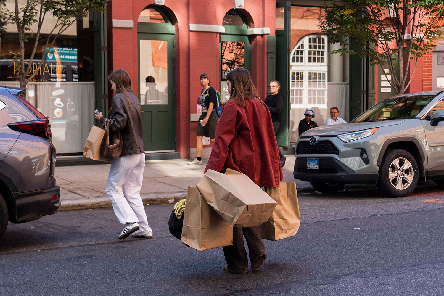 Shoppers leaving the sale with bags of merchandise. Photo / New York Times