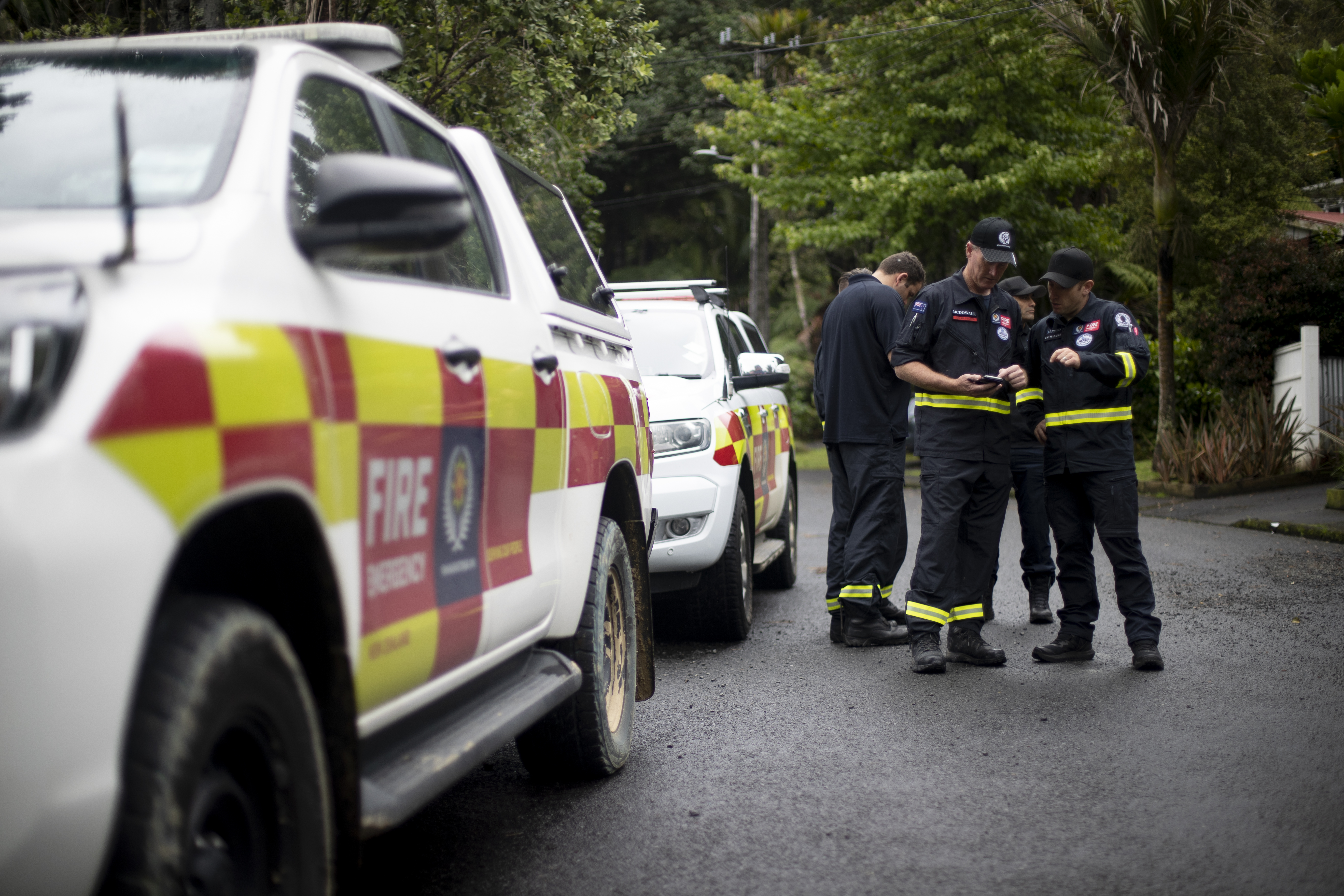 Members of Fenz Urban Search and Rescue working with structural engineers are assessing red-stickered homes in Titirangi after the devastating floods that hit Auckland. Photo / Dean Purcell