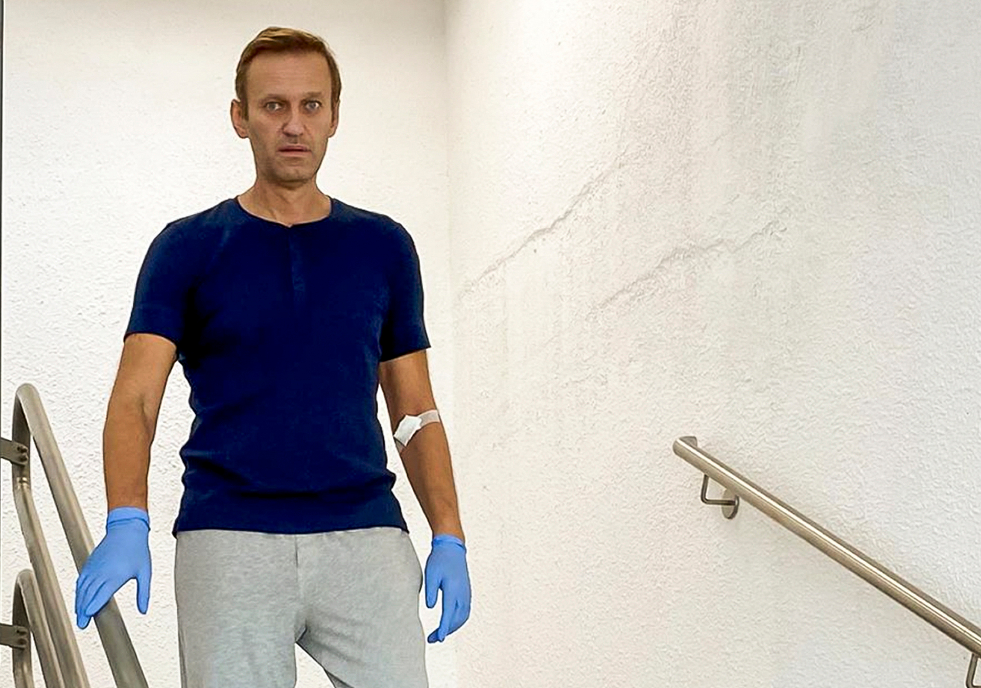 Russian opposition leader Alexei Navalny walks down stairs in a hospital in Berlin. Photo / AP