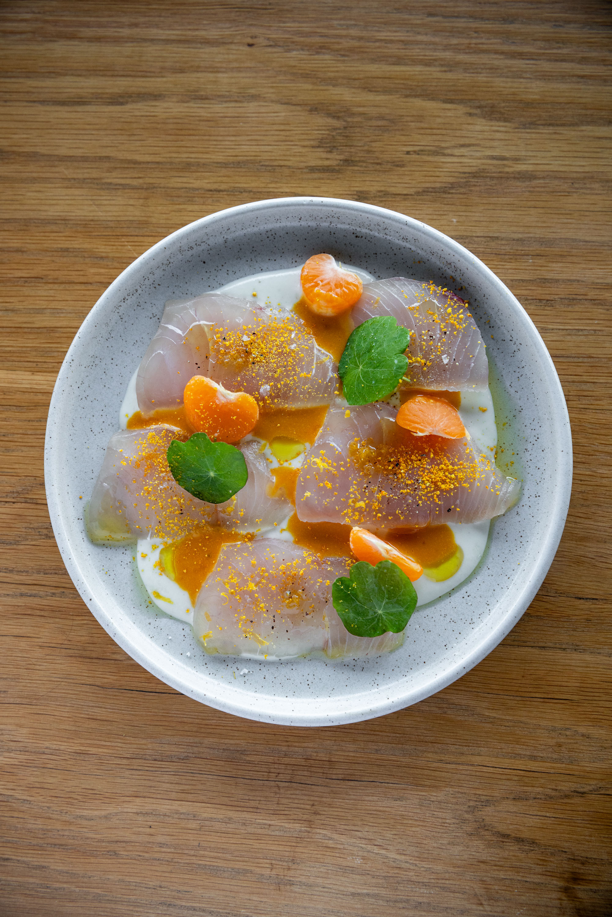 Parro's cured raw fish with white gazpacho, grapefruit, orange dressing and mandarin. Photo / Babiche Martens