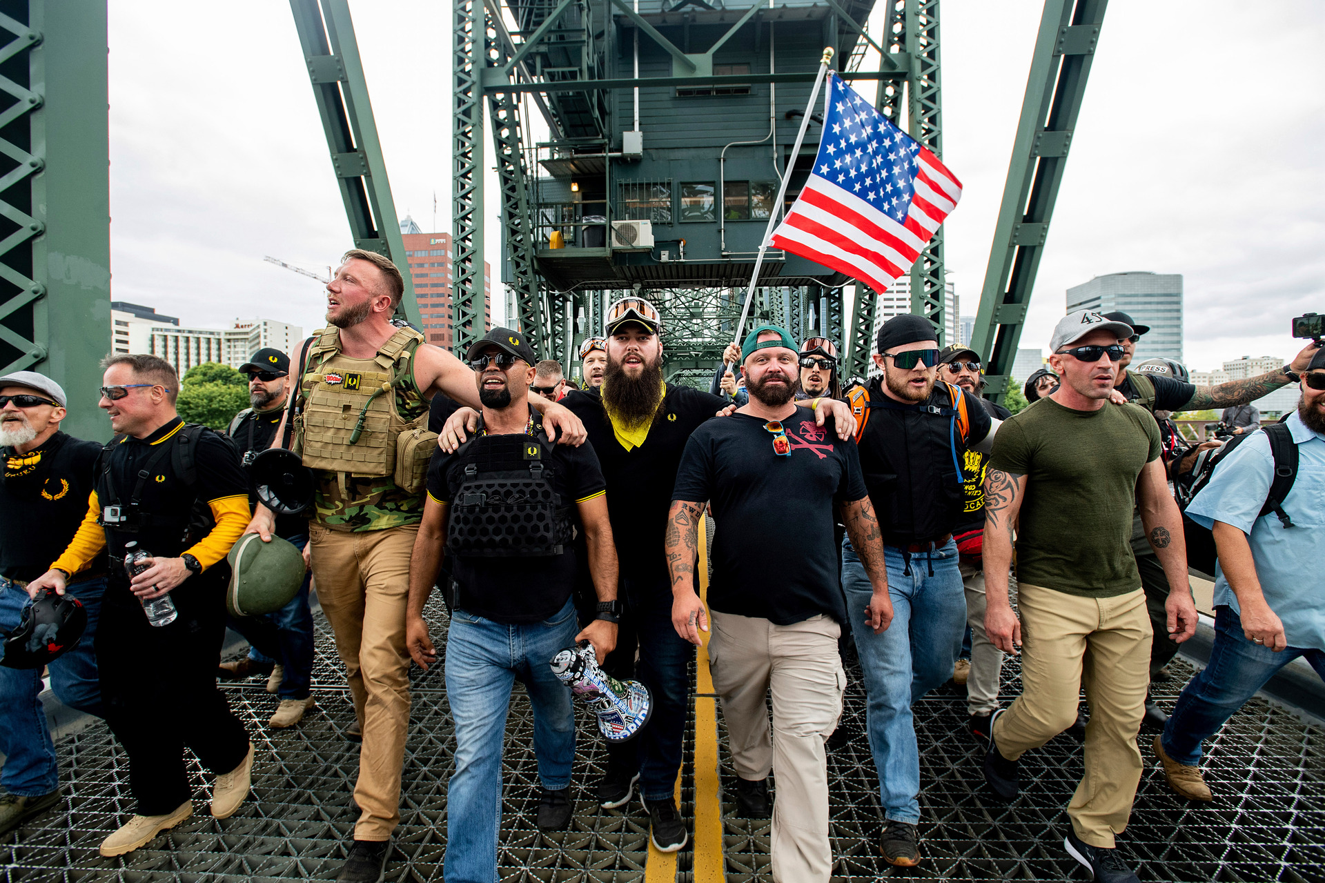 Members of the Proud Boys and other right-wing demonstrators march across the Hawthorne Bridge during a rally in Portland. Photo / AP