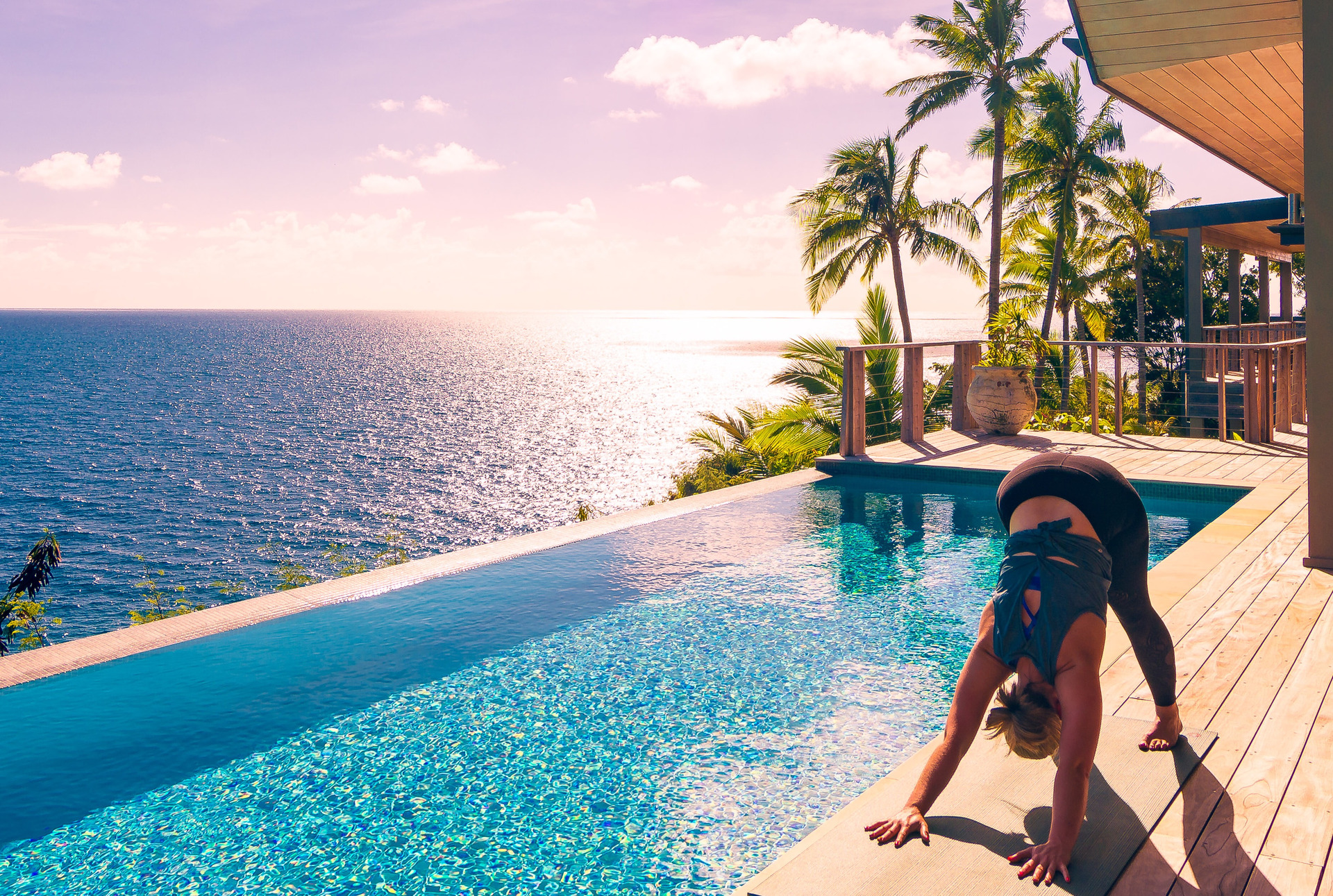 Juliette Sivertsen practices a downward dog atop Kokomo's luxury residence. Photo / Supplied