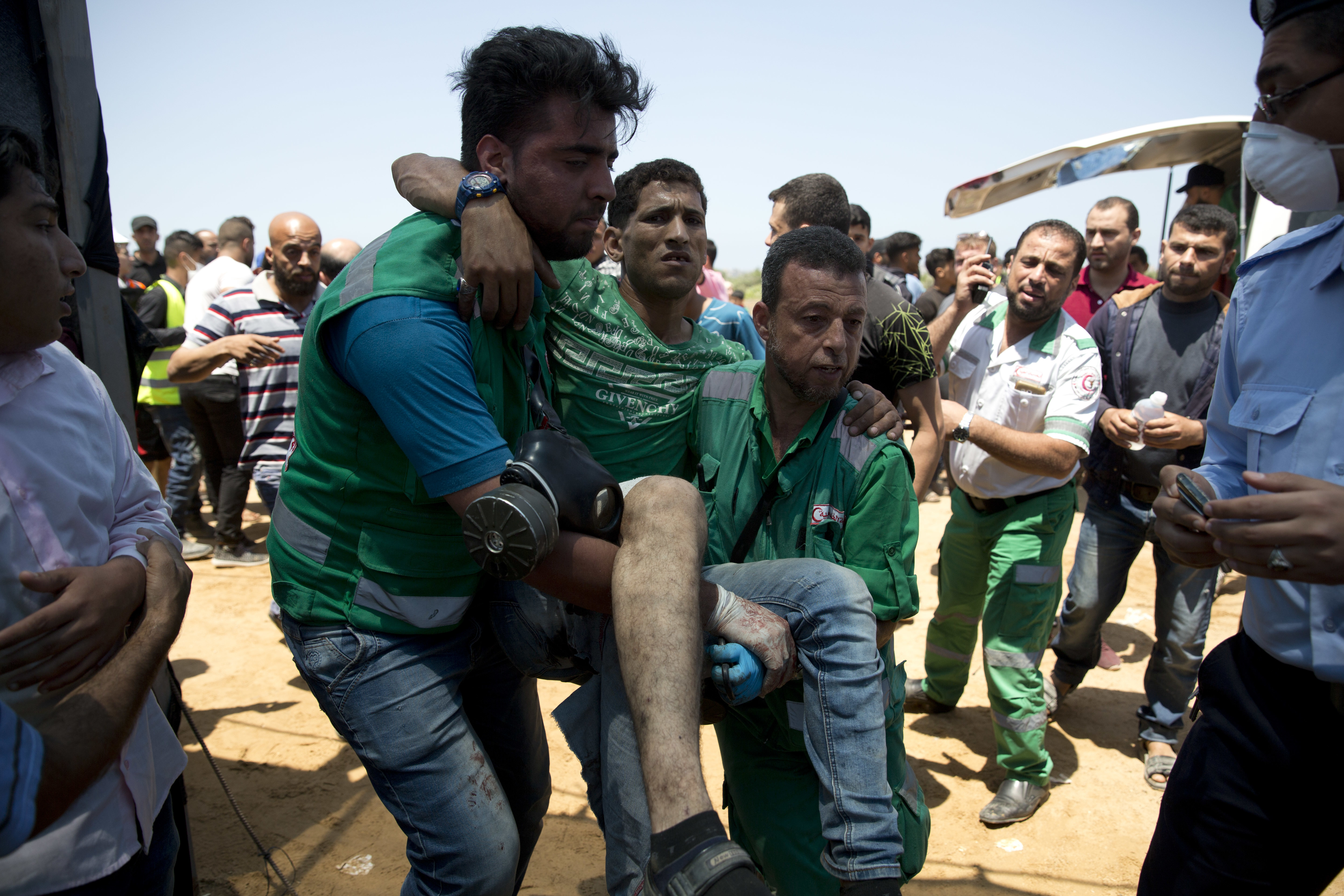 Medics assist a wounded Palestinian during a protest near Beit Lahiya, Gaza Strip. Photo / AP