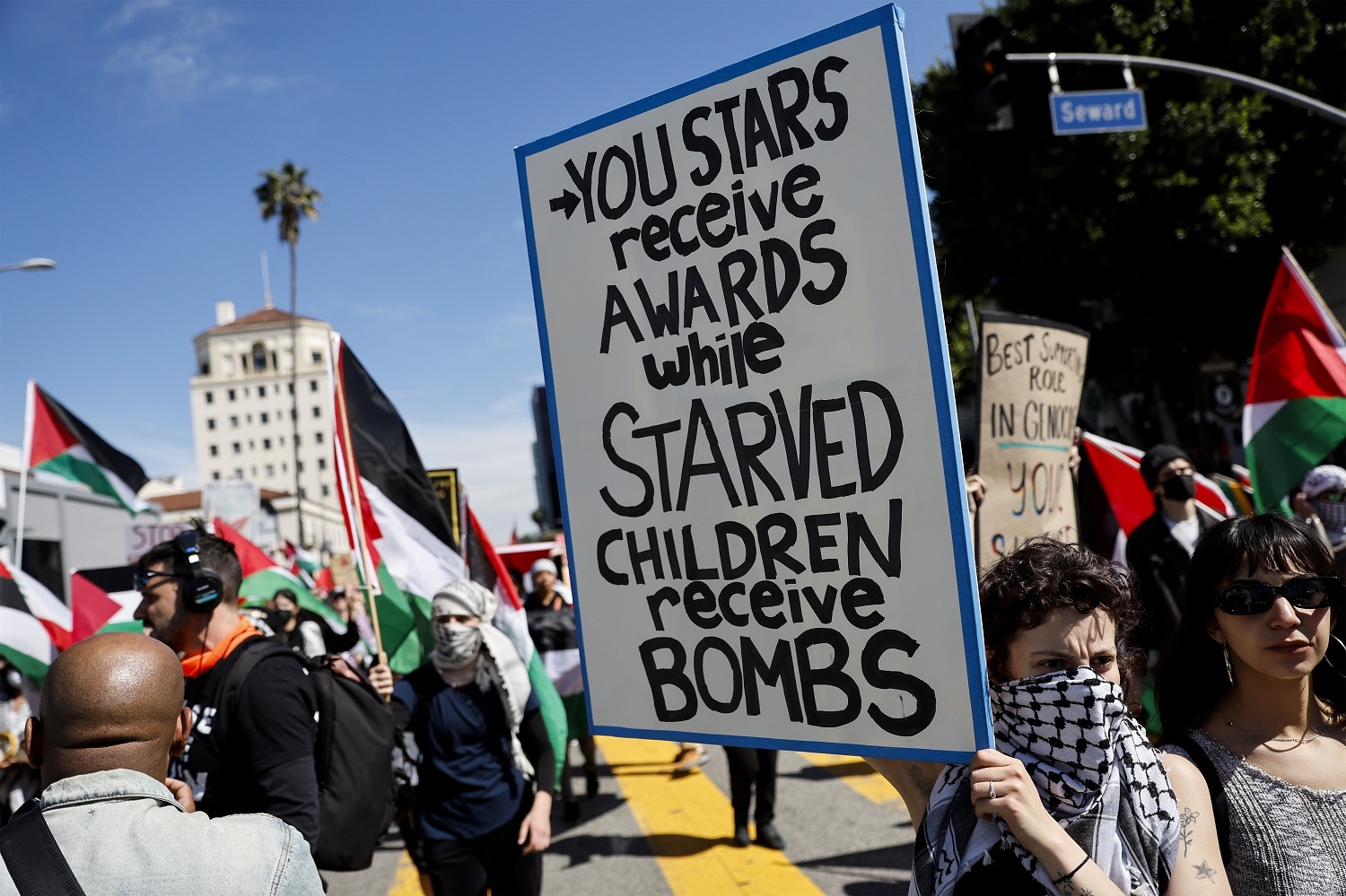 A protester holds a poster during a demonstration in support of Palestinians calling for a ceasefire in Gaza. Photo / AP