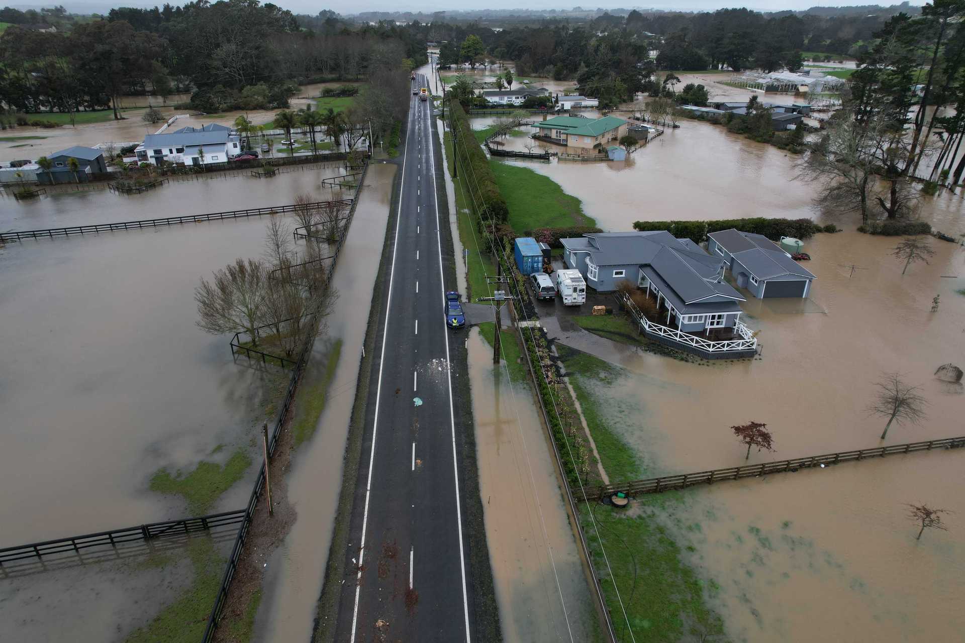 Flooding along Waitakere Road at Taupaki. Photo / Brett Phibbs