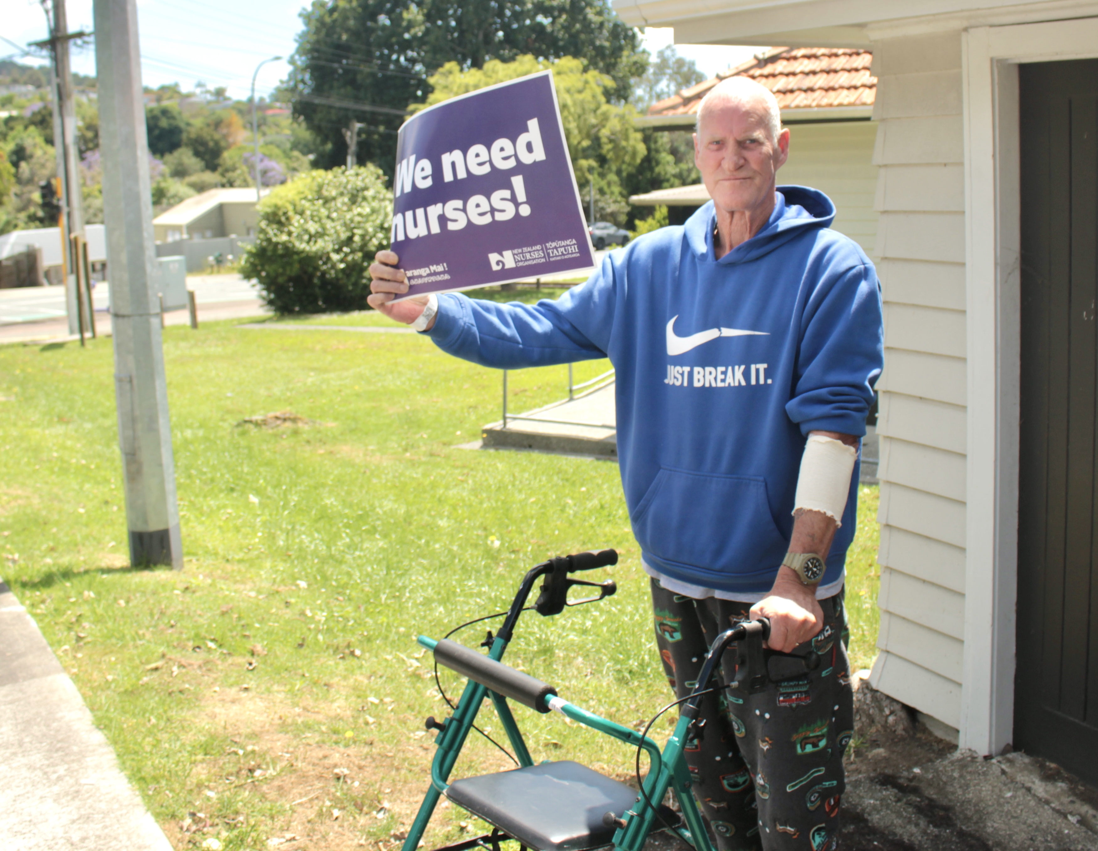 Whangārei Hospital patient Grant McKean was happy to wave a sign in support of the nurses' strike, saying nurses are the healthcare professionals patients see every day. Photo / Denise Piper
