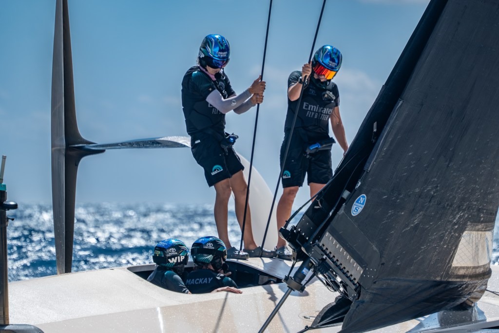 Liv Mackay at the helm of the Team NZ AC40 talks to crewmates during training off Barcelona. Photo / ETNZ