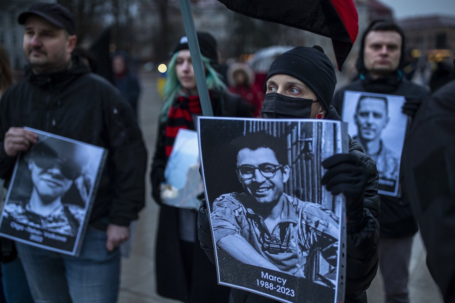 People holds photos of those who died in the war during a protest marking the two-year anniversary of Russia's full-scale invasion of Ukraine, in Vilnius, Lithuania. Photo / AP