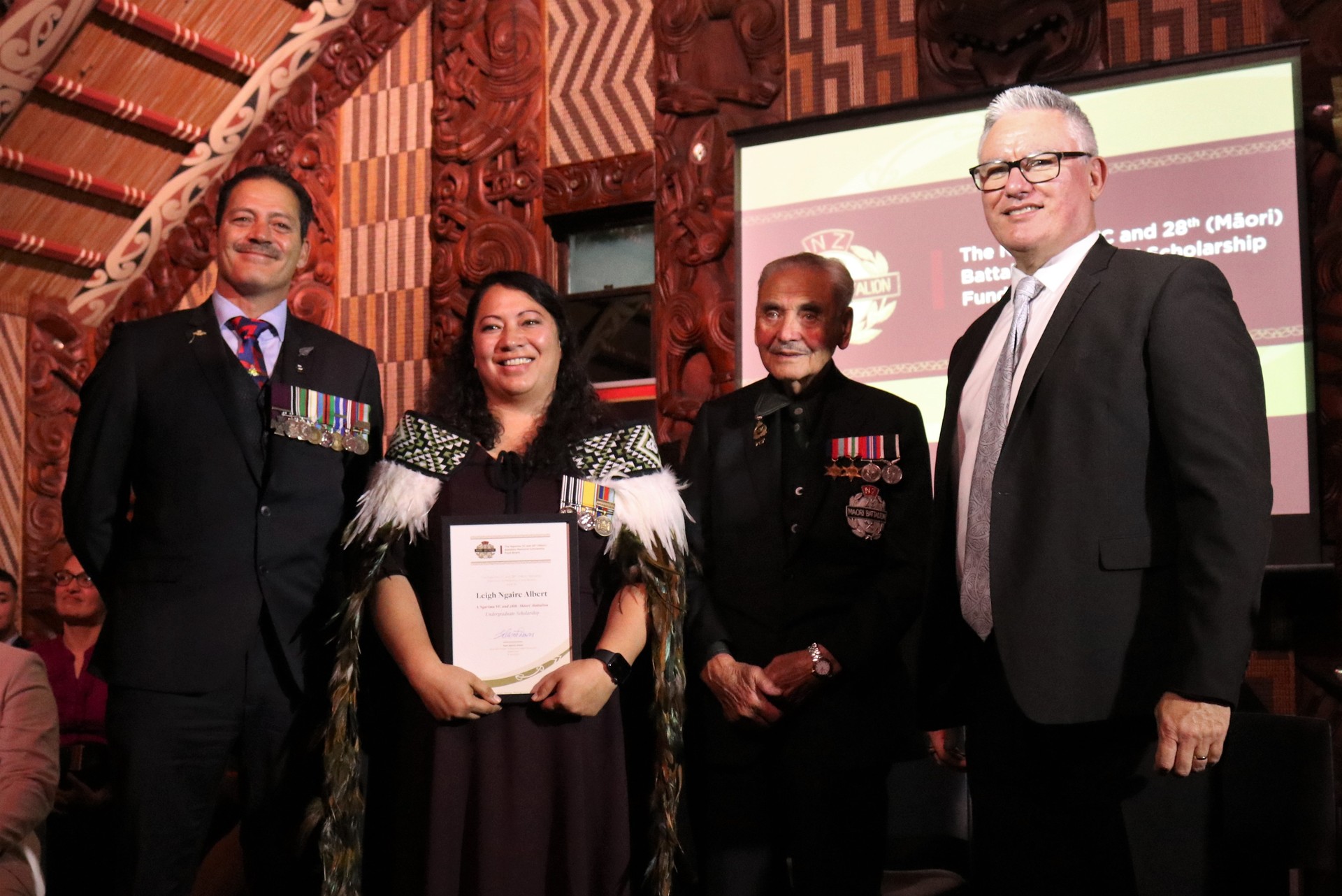 Undergraduate scholarship winner Leigh Albert with, from left, VC recipient Willie Apiata, Māori Battalion veteran Sir Robert “Bom” Gillies and Associate Education Minister Kelvin Davis. Photo / Peter de Graaf