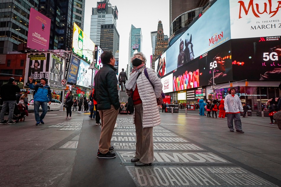 Pedestrians wearing face masks in Times Square. Photo / AP, File